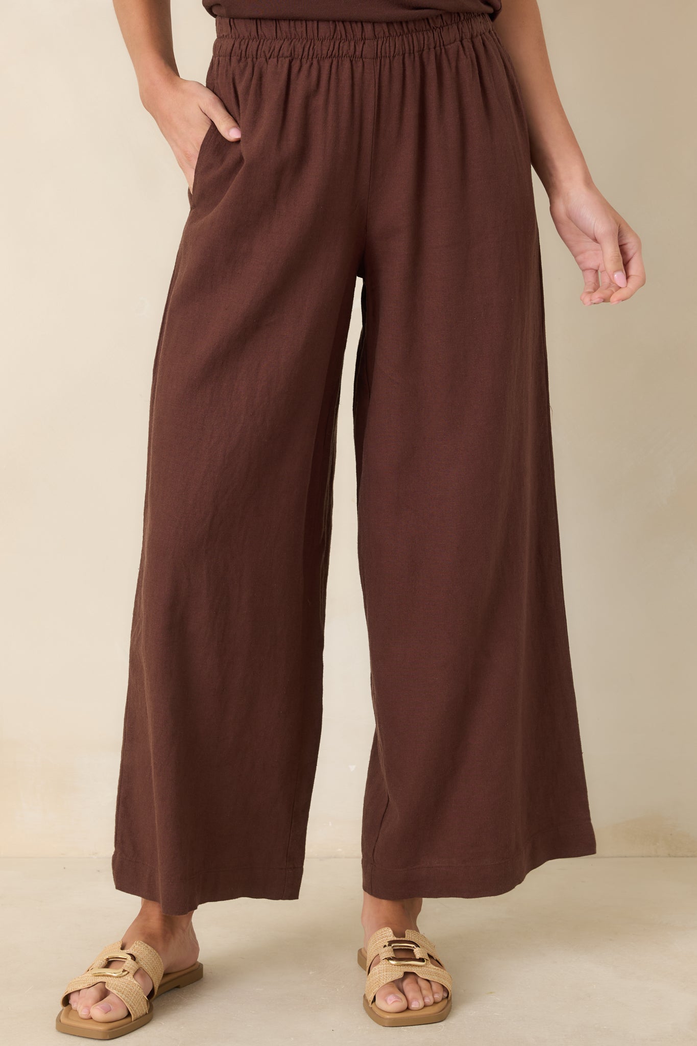 Cropped view of upper pant section showing elastic waistband and smooth linen fabric texture.