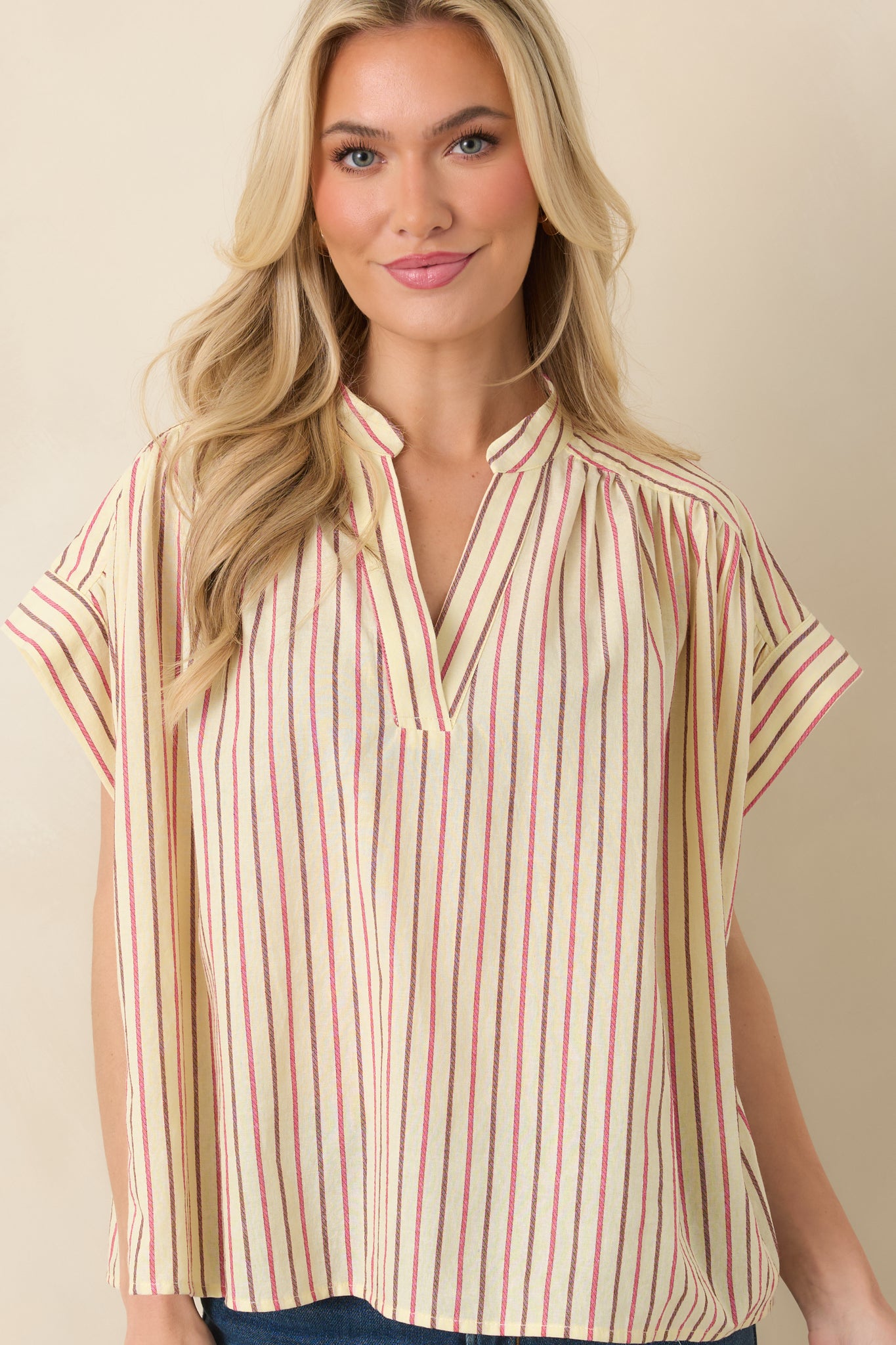 Close view of split V-neckline and stand collar detail.