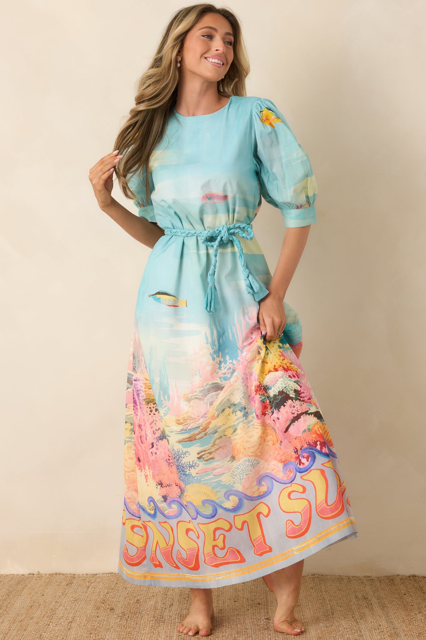 Breezy maxi dress with round neckline, puffed elbow-length sleeves, and adjustable tie waist.