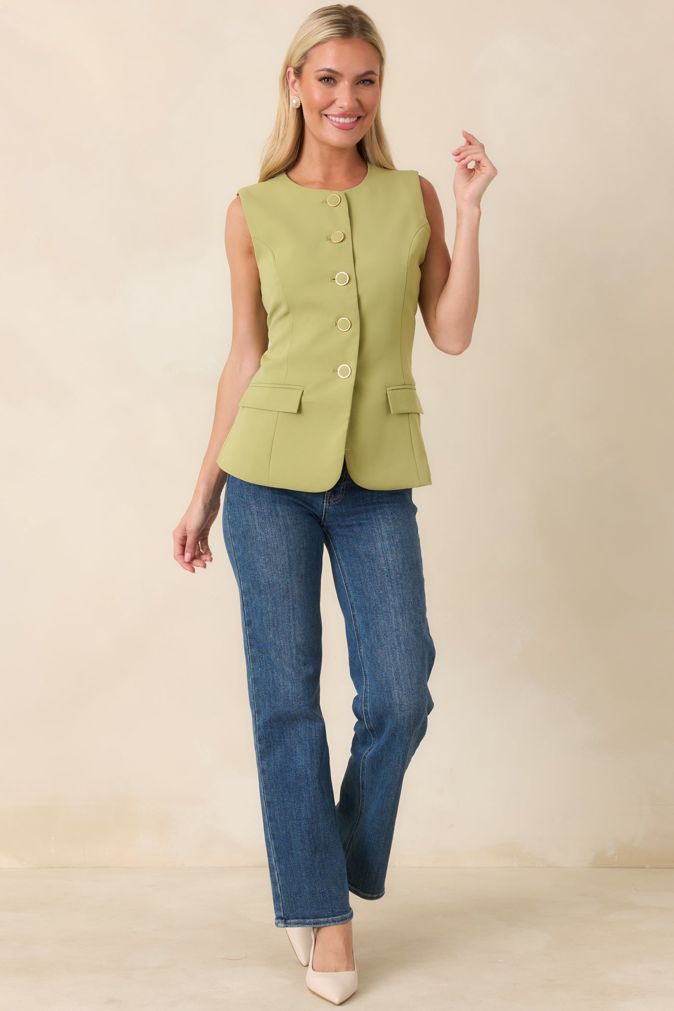 Tailored green sleeveless top designed with a semi-fitted silhouette, decorative welt flap pockets, and a fully lined woven construction.