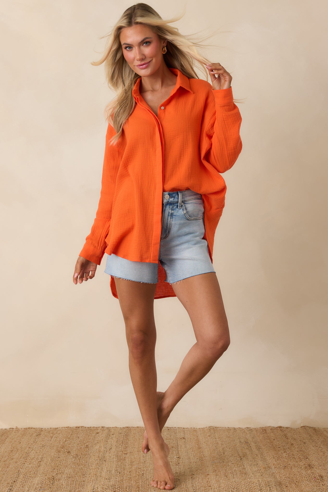 Cotton button-up with breathable fabric, subtle texture, and high-low hemline.