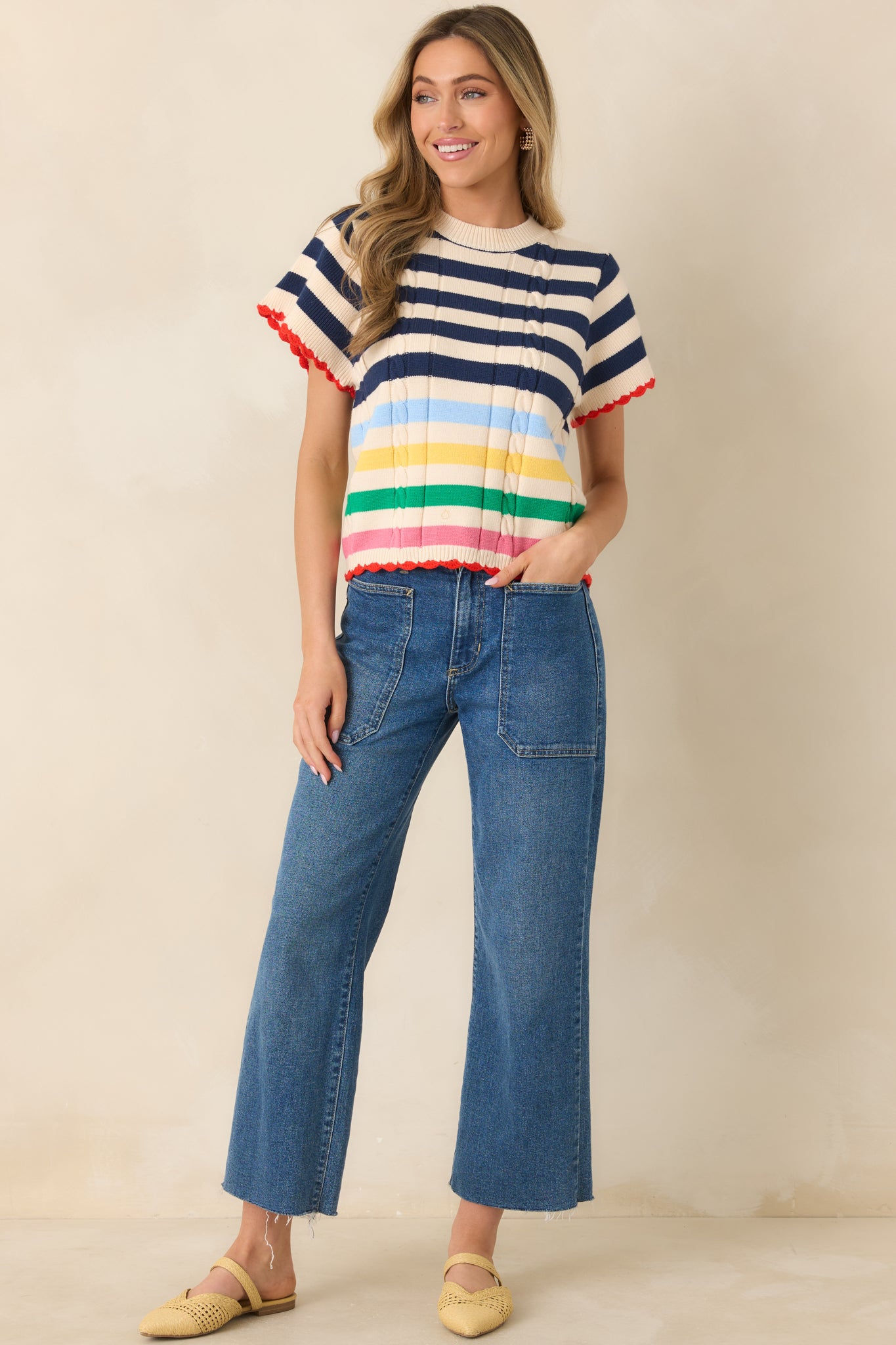 Navy striped knit top with textured vertical stitching and scalloped edging.