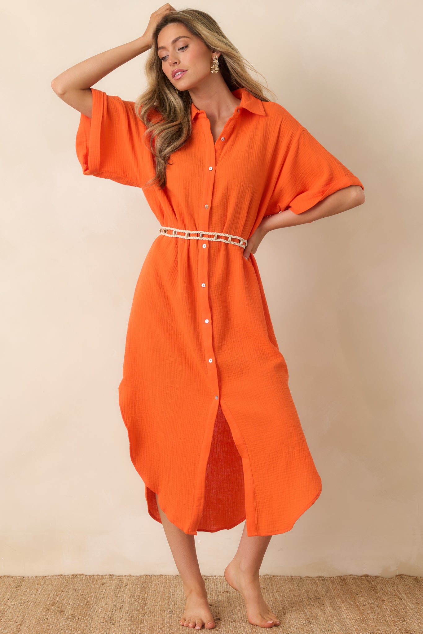 Relaxed-fit midi dress with vibrant orange hue and softly curved hem.