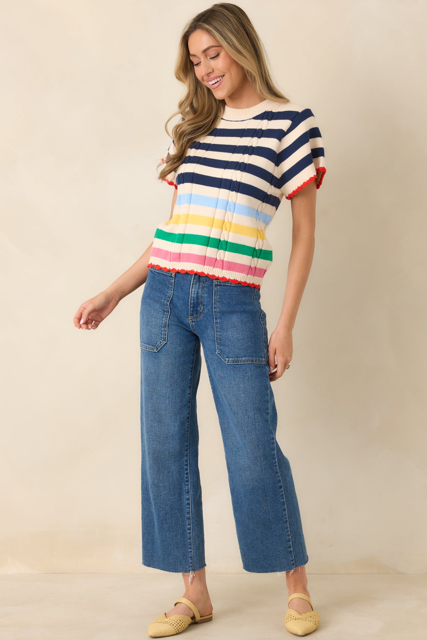 Knit top with navy stripes, colorful accents, and subtle scalloped trim.