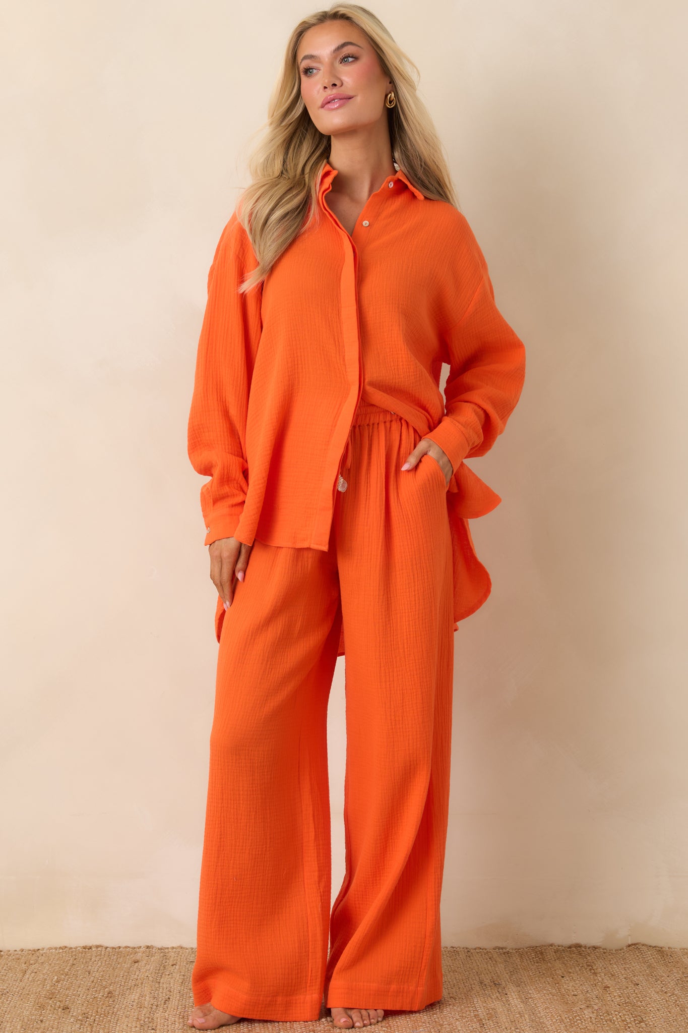 Orange cotton button-up with relaxed fit, classic collar, and long roll-tab sleeves.