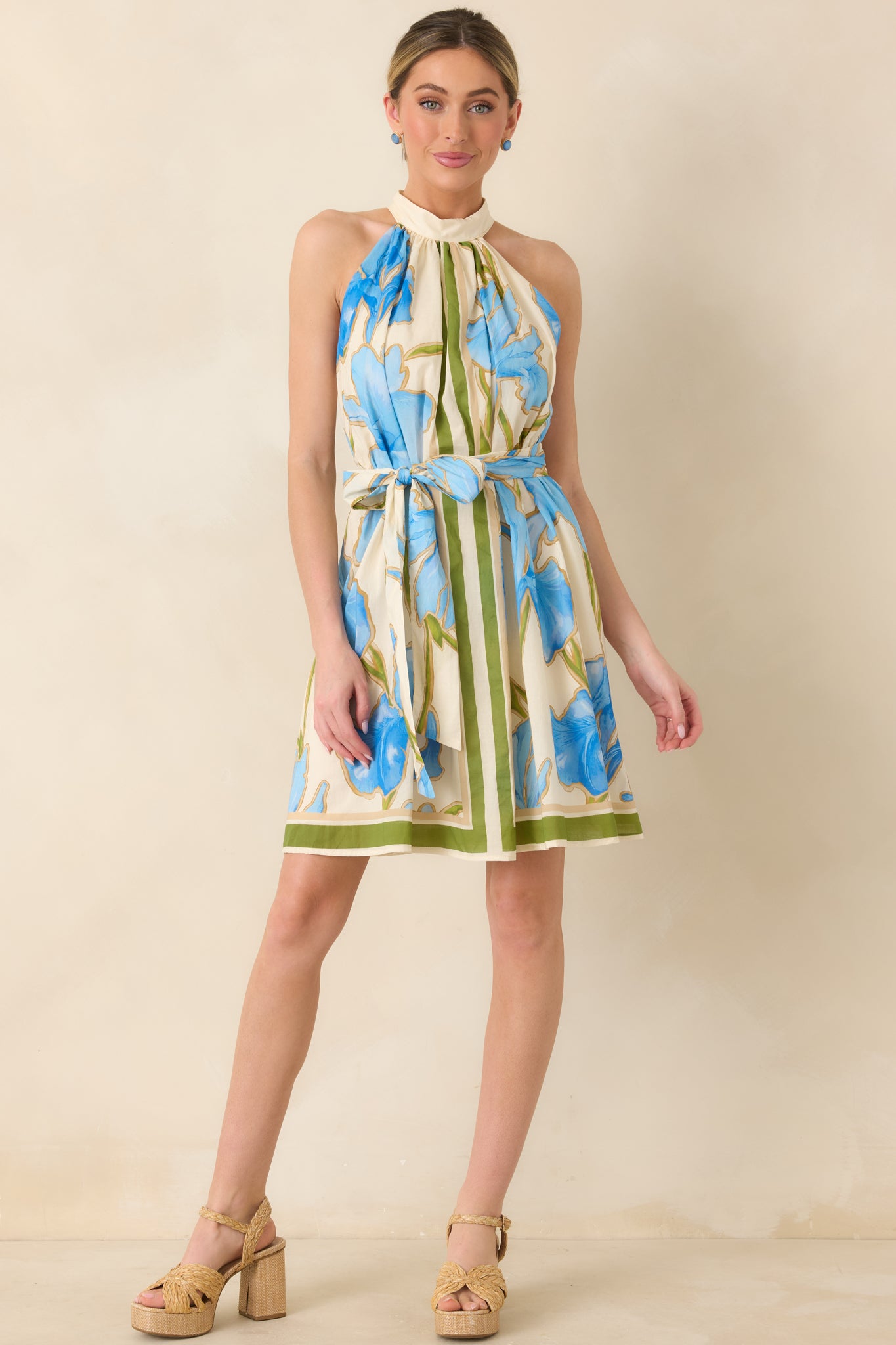 Floral mini dress with olive stripe framing, halter neckline, and easy movement.
