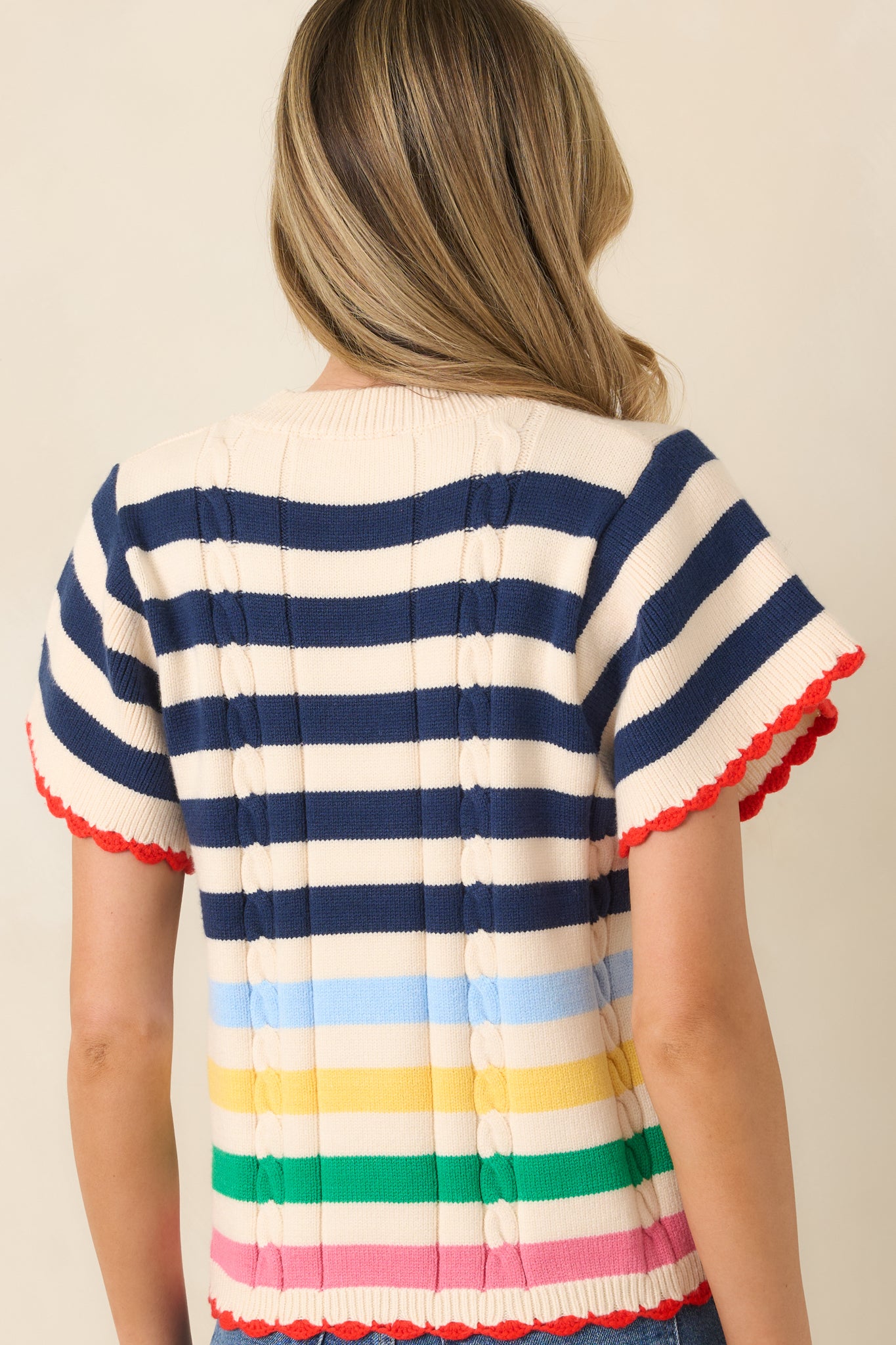 Soft knit top with navy stripes and relaxed silhouette.