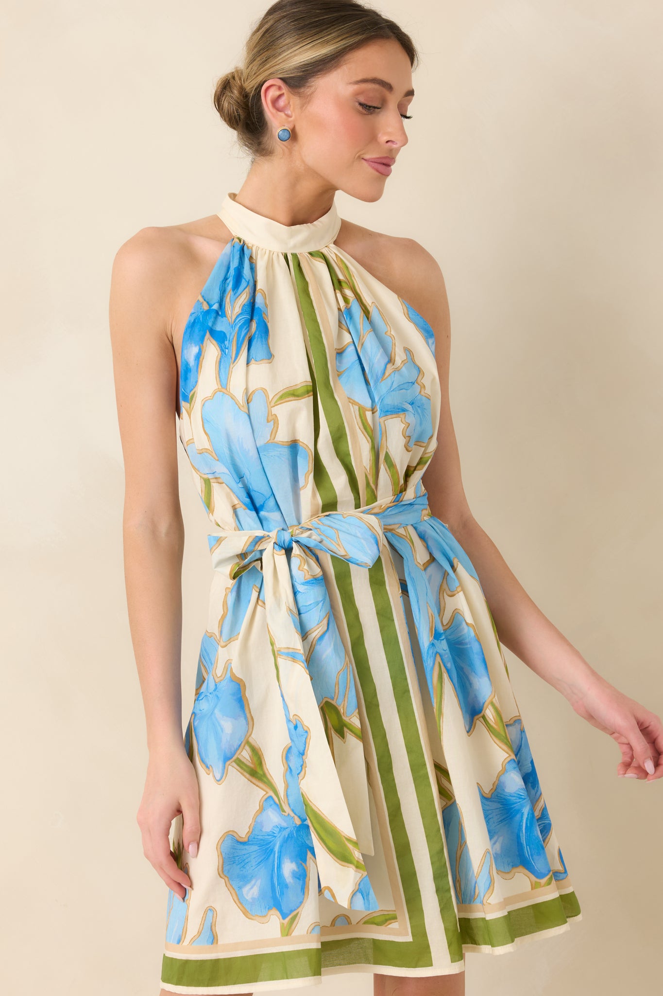 Close view of halter neckline with blue floral print and olive stripe details.