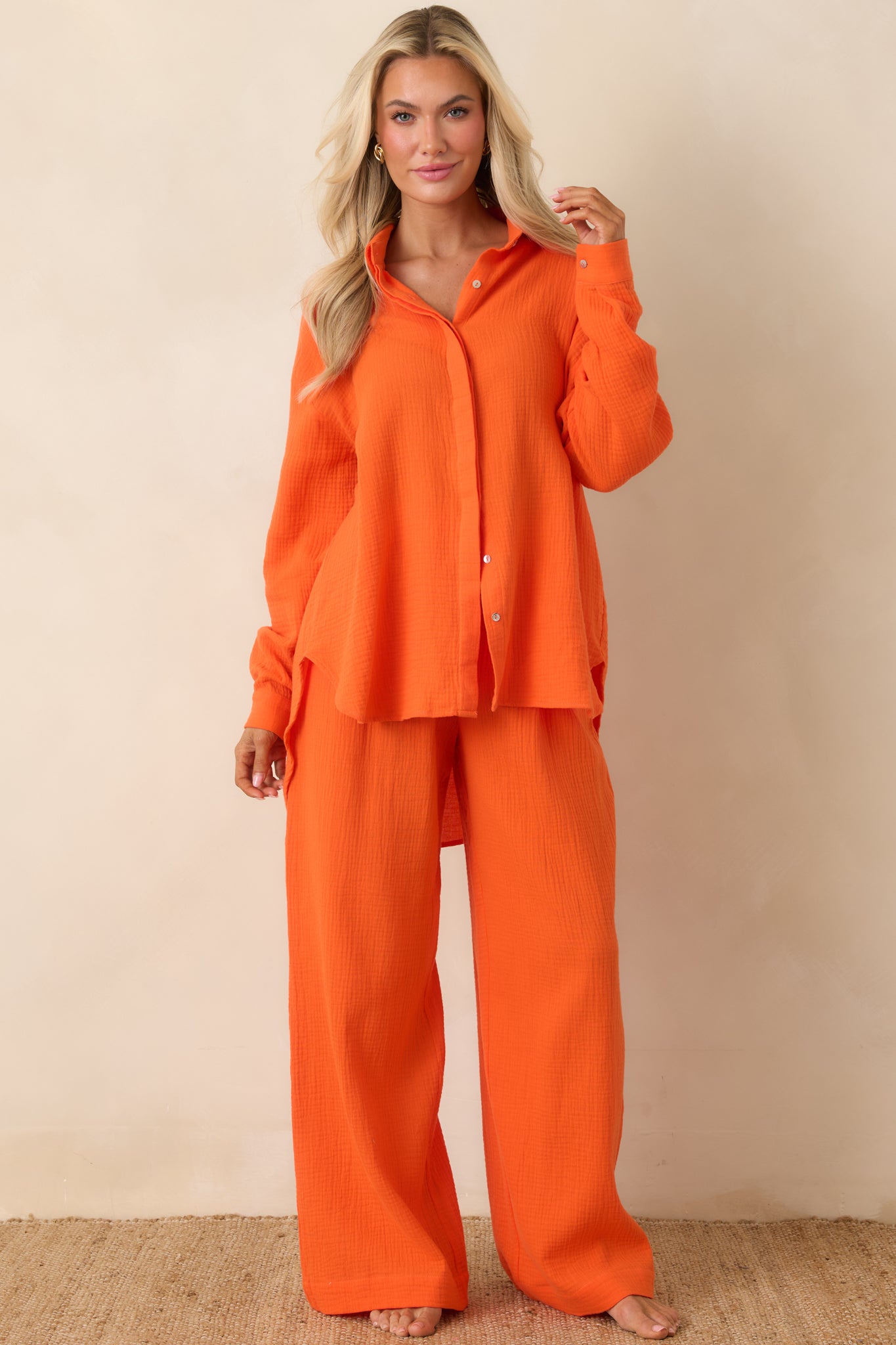 Lightweight gauze-style top featuring full front buttons and slightly oversized silhouette.