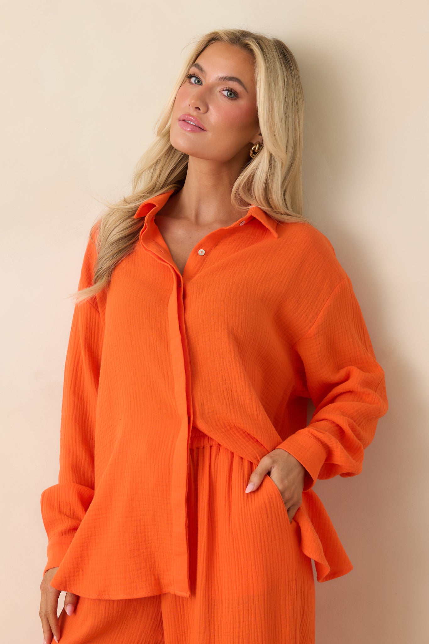 Detailed look at the roll-tab long sleeves and breathable gauze-style texture.