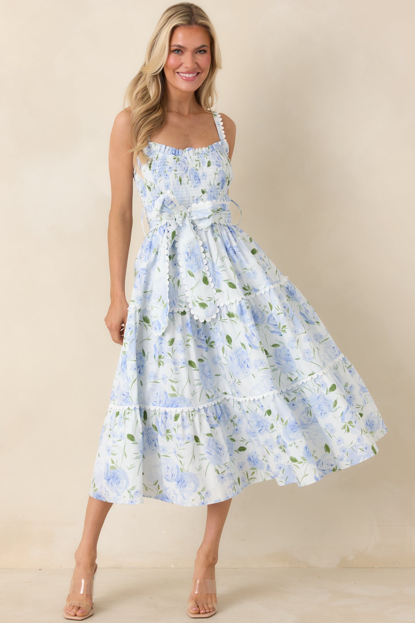 Front view of blue maxi dress featuring smocked bodice, square neckline, and tiered flowing skirt.