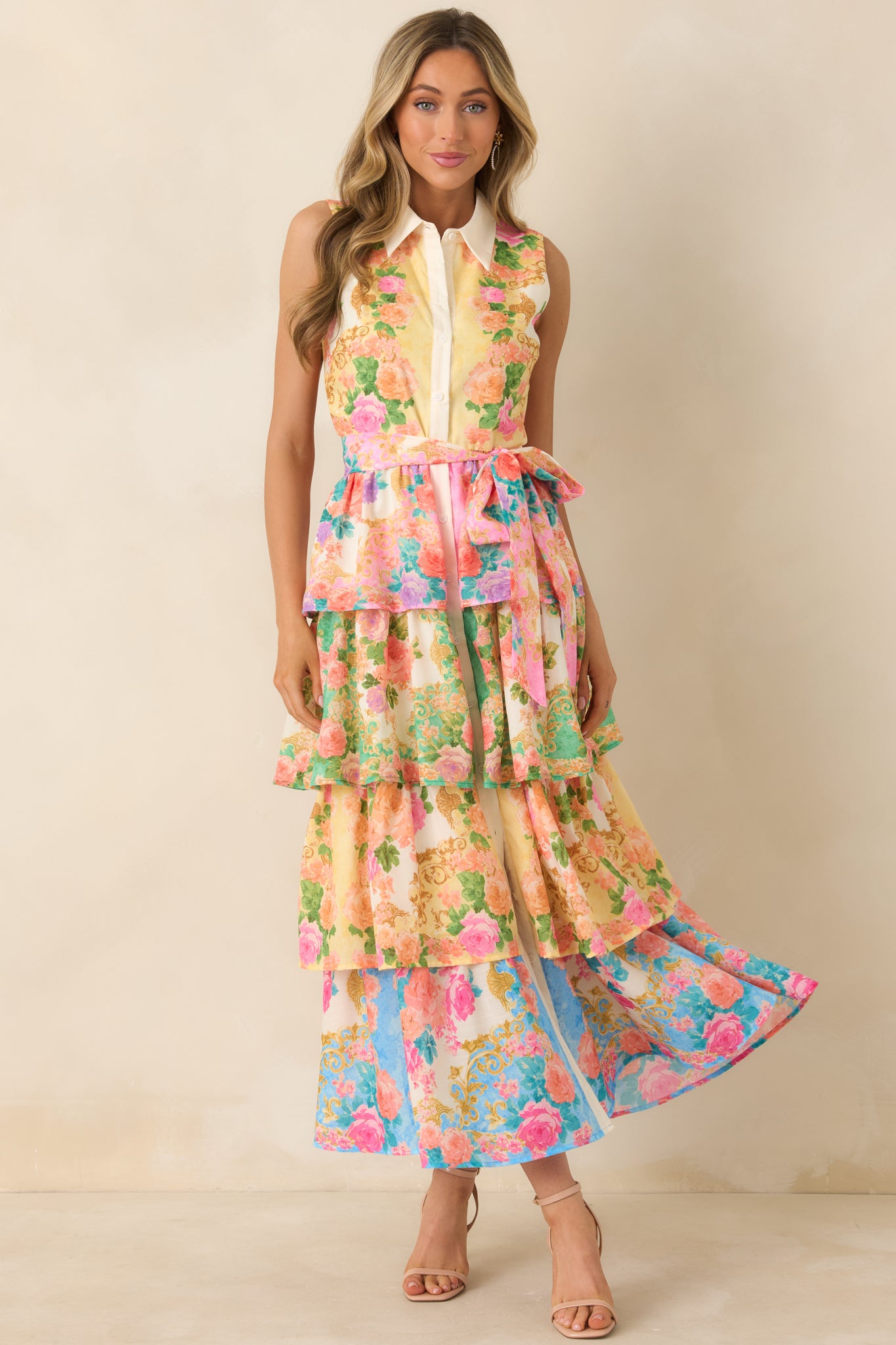 Sleeveless yellow dress with polished bodice, flowing tiered skirt, and vibrant floral accents.