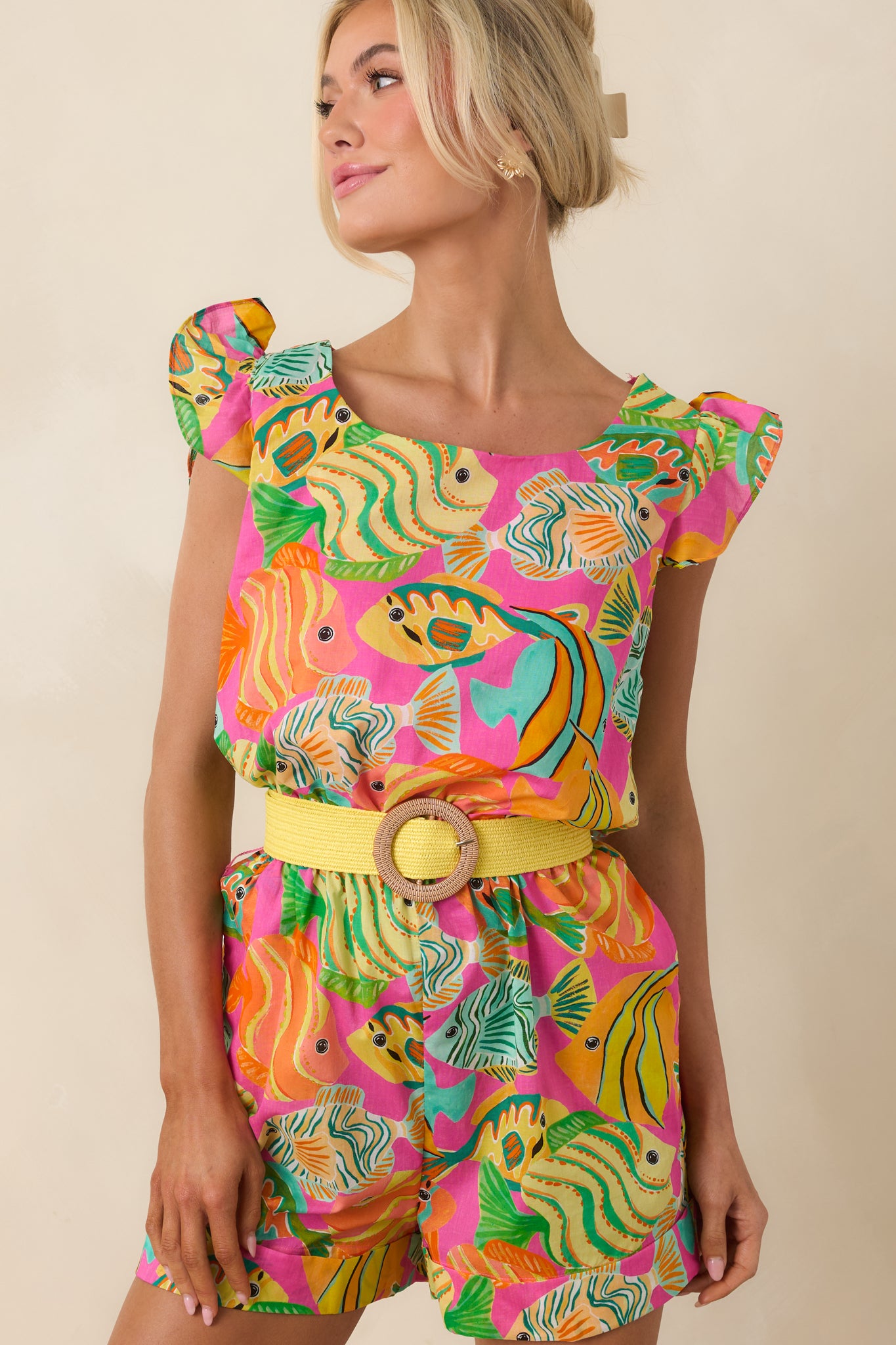 Romper highlighting the colorful print, flutter sleeves, and soft cotton fabric.