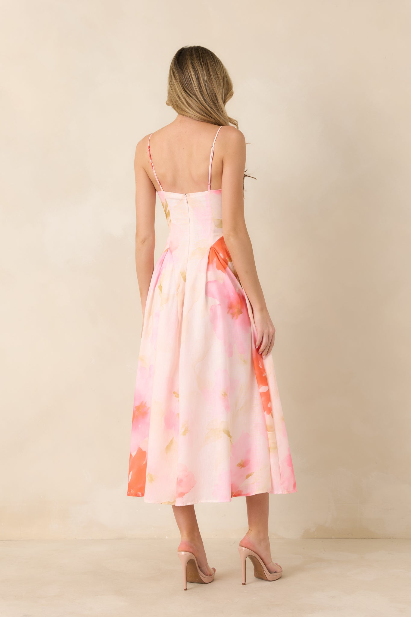 Rear view of midi dress showing concealed back zipper, fitted waist, and softly draped A-line skirt.