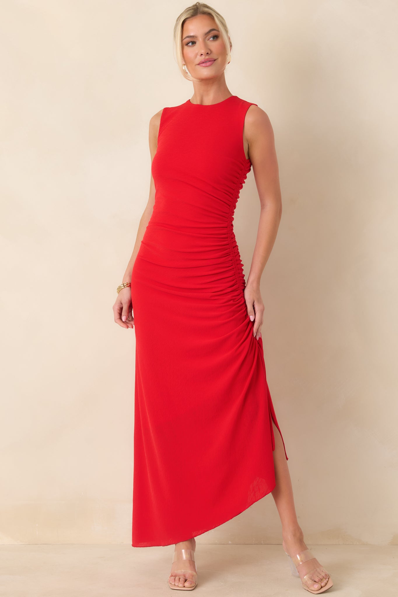 Red midi dress with a streamlined sleeveless silhouette, round neckline, and adjustable side ruching that refines the overall shape.
