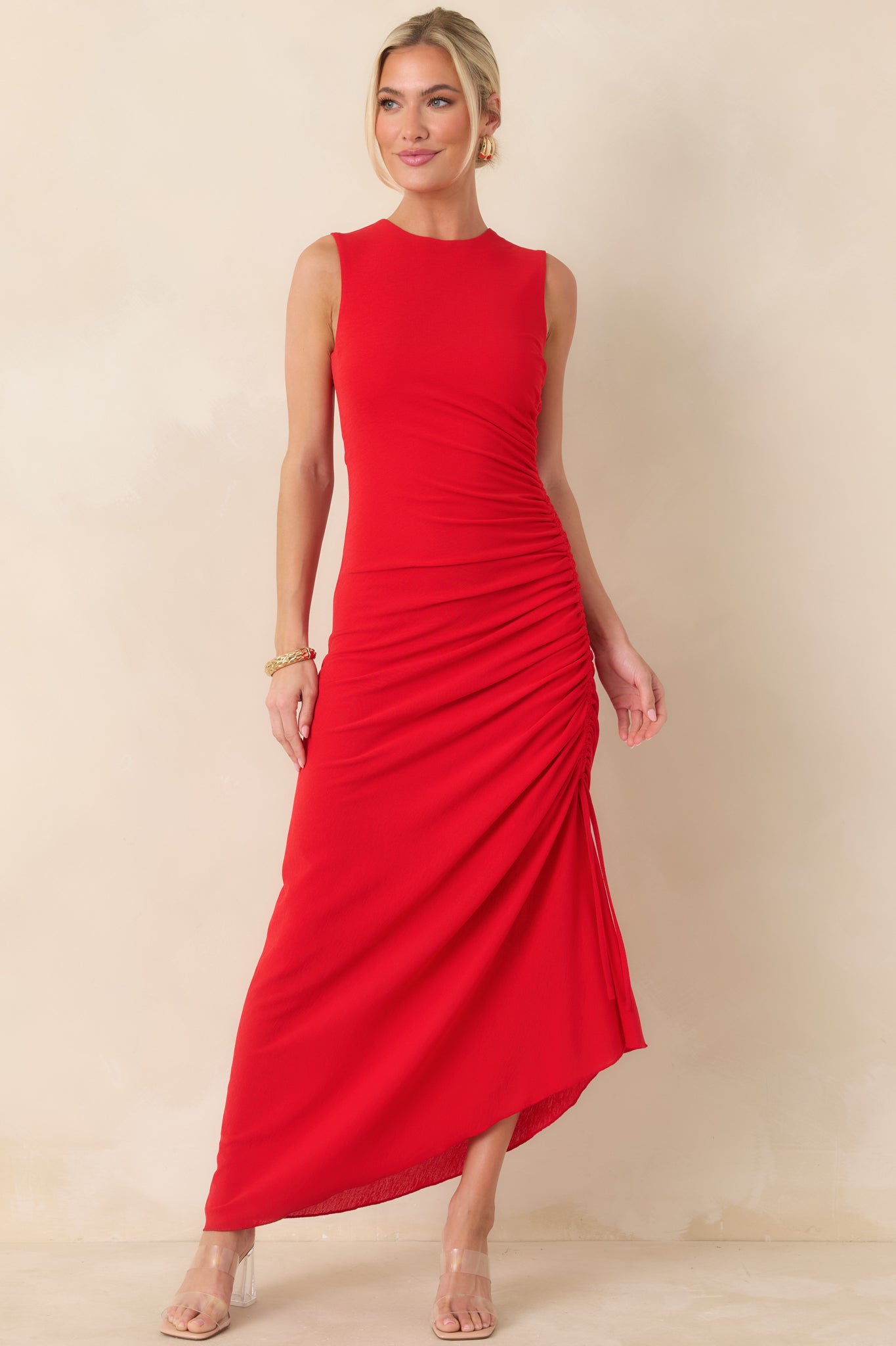 Red sleeveless midi dress designed with side drawstring detailing that creates subtle ruching and a softly shaped silhouette.