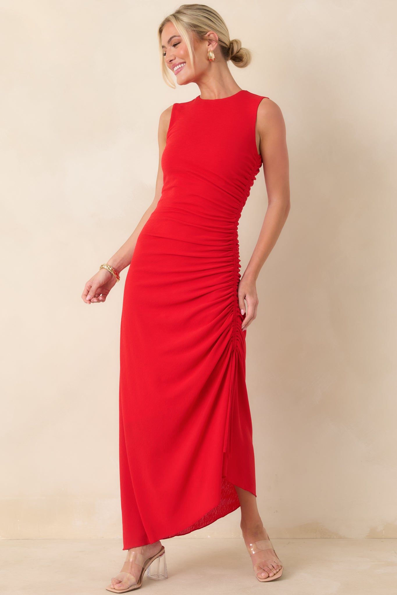 Red midi dress showcasing a smooth pull-on construction with adjustable side ties that enhance contour and movement.