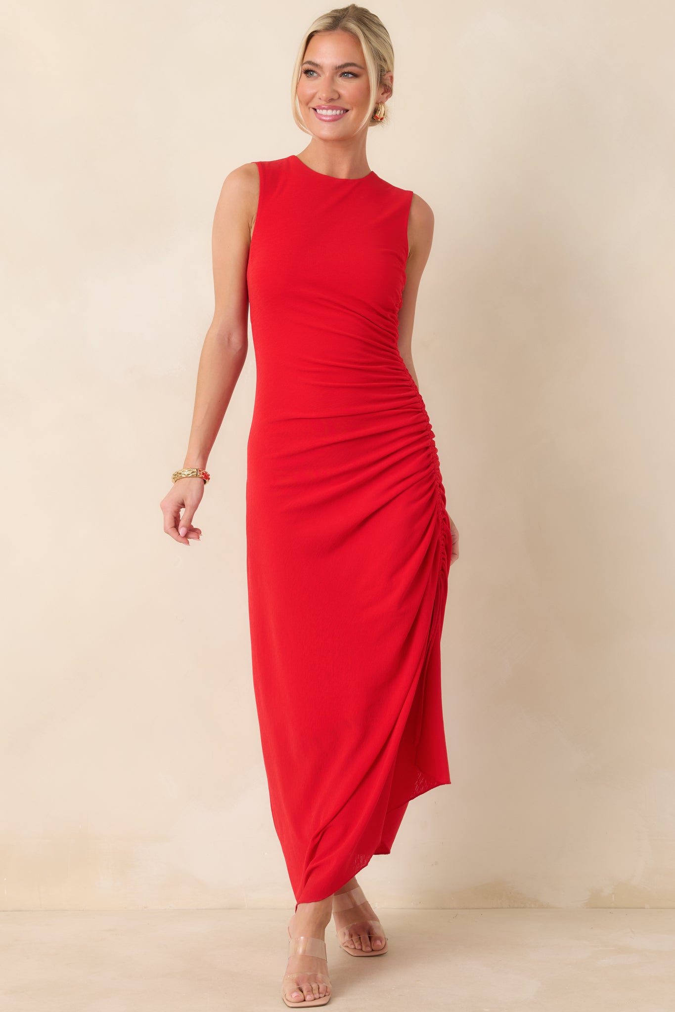 Vibrant red midi dress with a clean round neckline and gathered side detailing for adjustable shaping and hem variation.