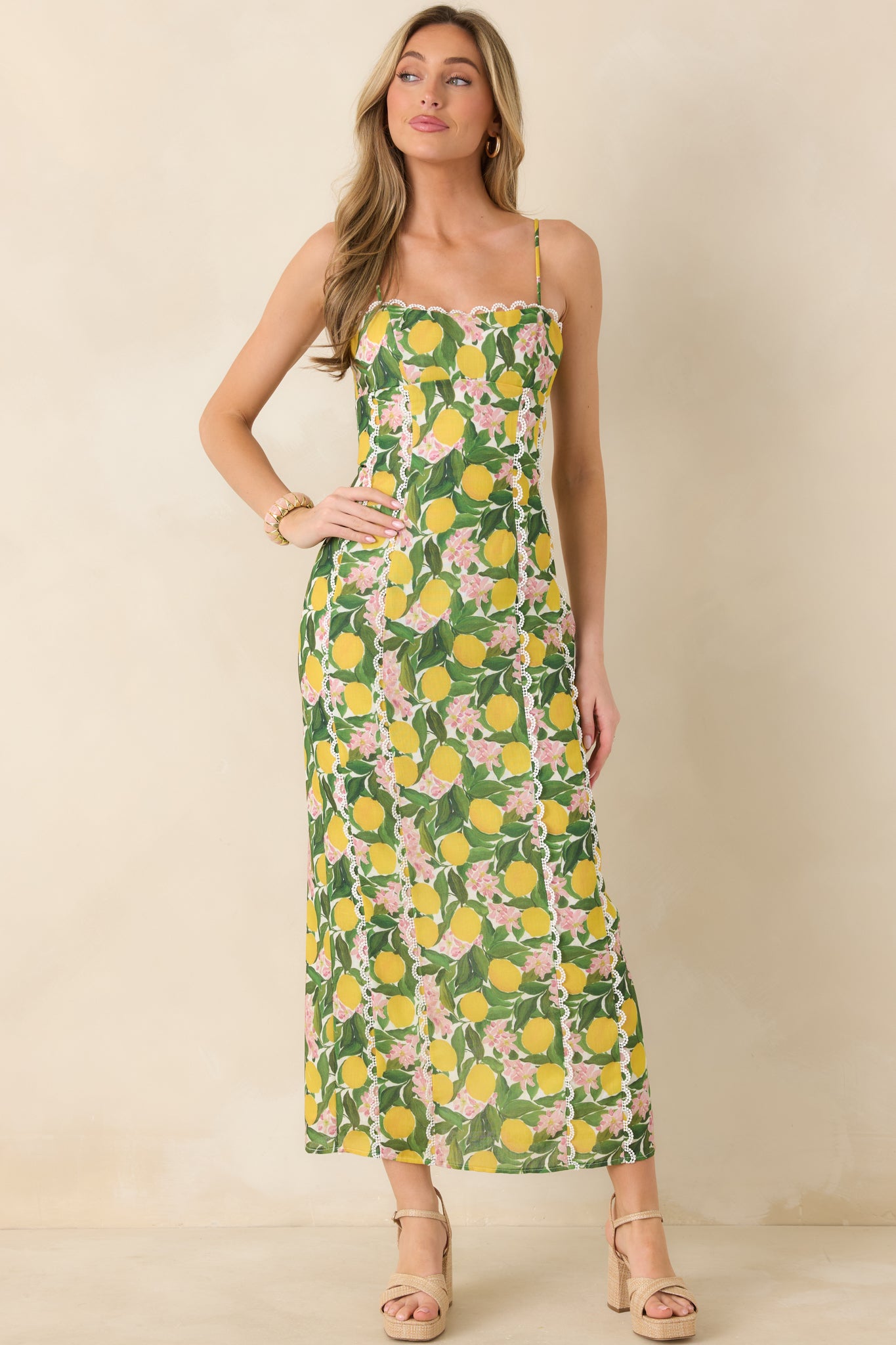 Lemon-print maxi dress with vertical seam accents, a tailored fitted bodice, and a clean straight skirt for a streamlined finish.
