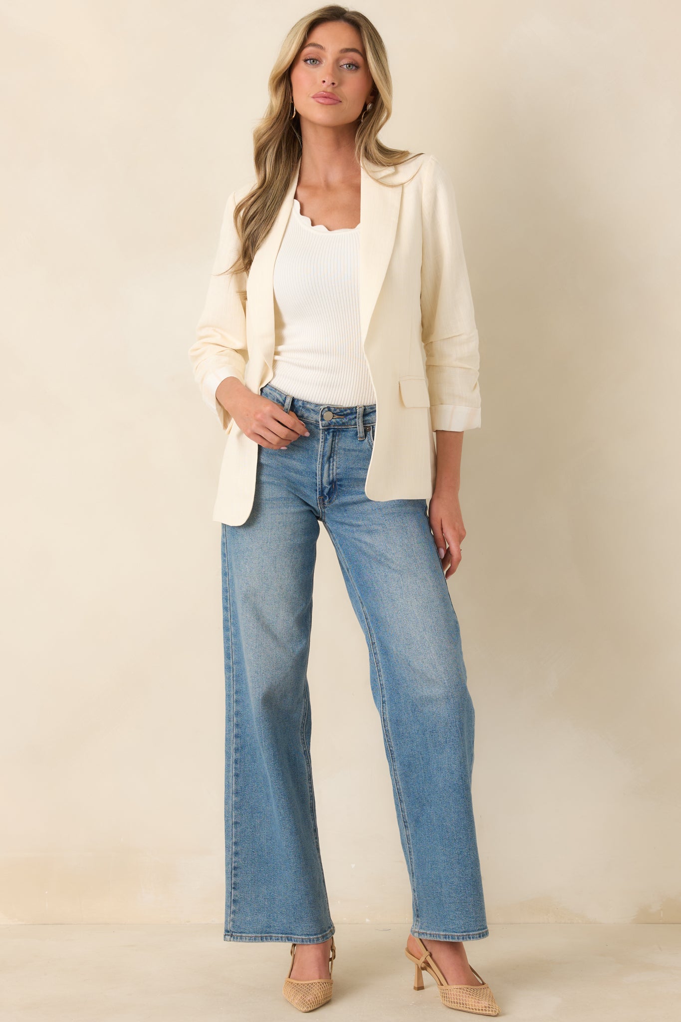 Ivory blazer with soft ruching at the 3/4 sleeves, crisp lapels, and a clean, elongated silhouette.