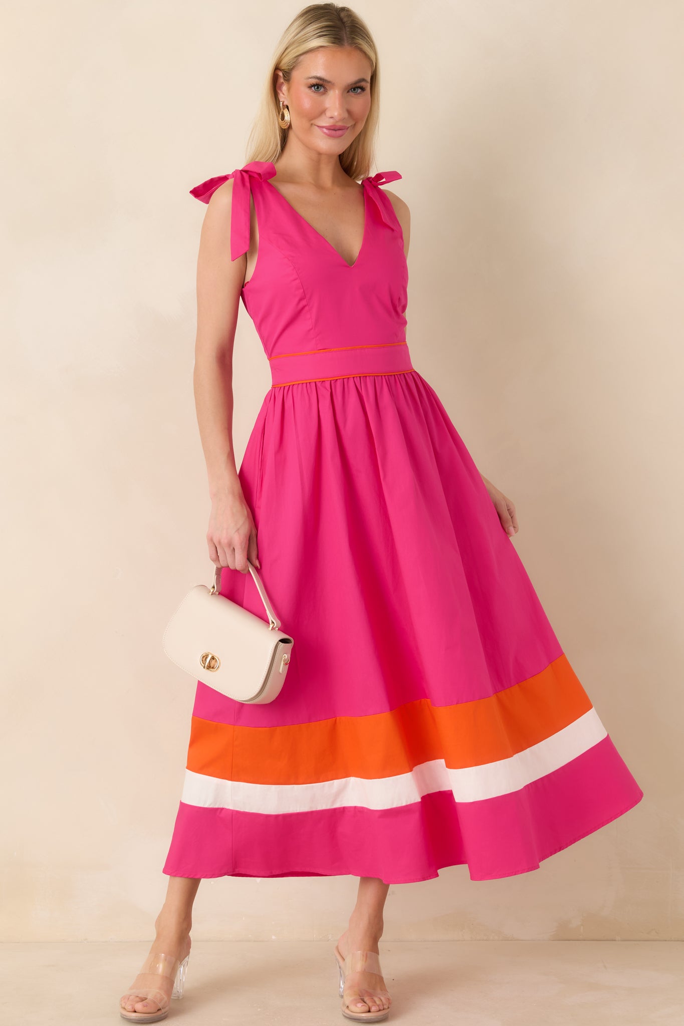 Fuchsia midi dress with V-neckline, tie shoulder straps, and colorblock hem.
