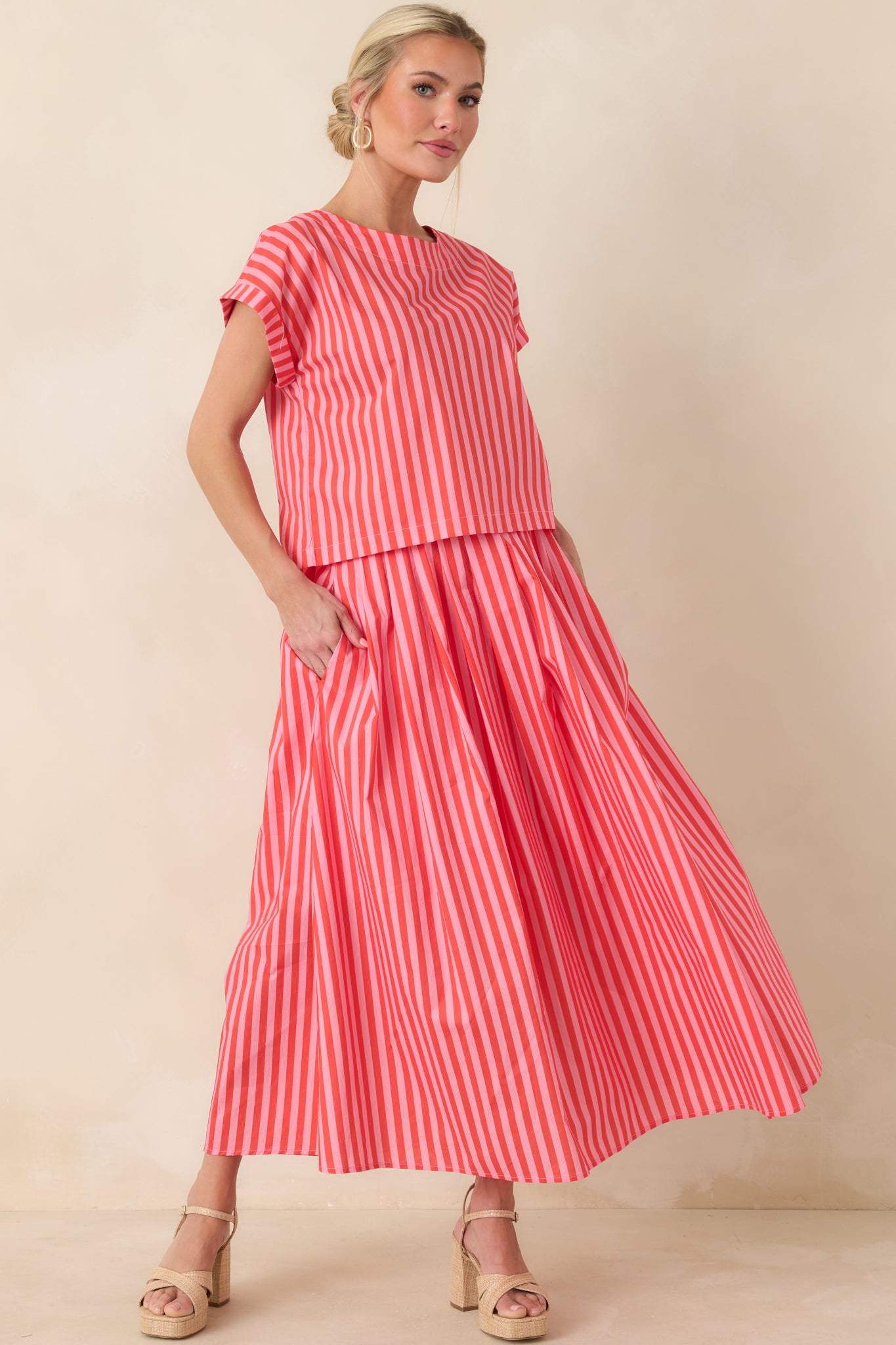 Boxy-fit cotton top with vertical orange and pink stripes, relaxed silhouette, and slightly cropped length for easy proportion.