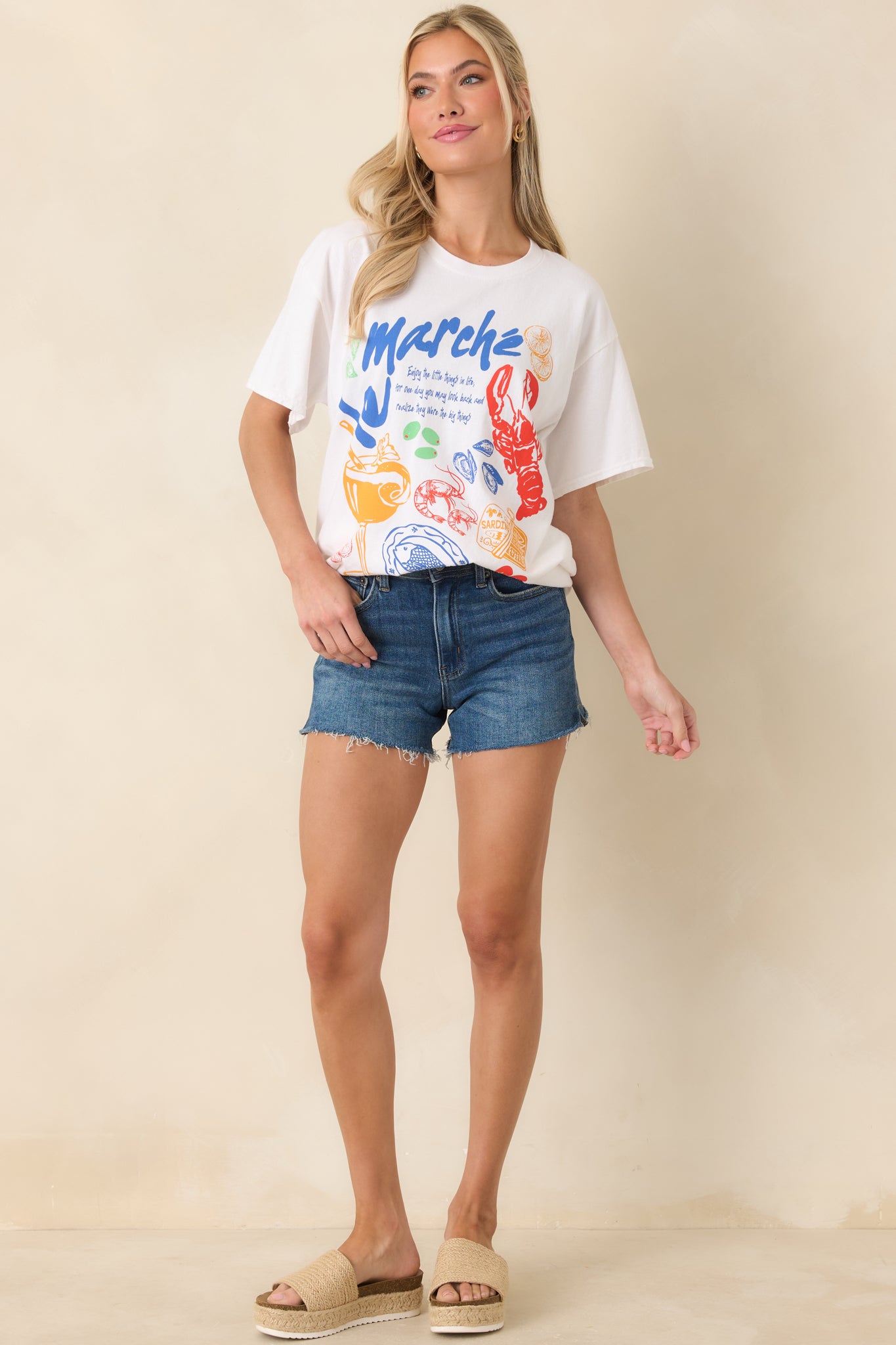 Lightweight cotton tee in white with a loose fit, short sleeves, and eye-catching multicolor front design.