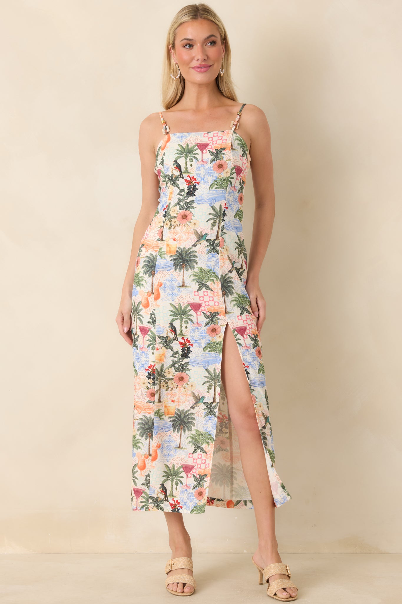 Vibrant, tropical print midi dress with delicate beaded straps and flowing silhouette.