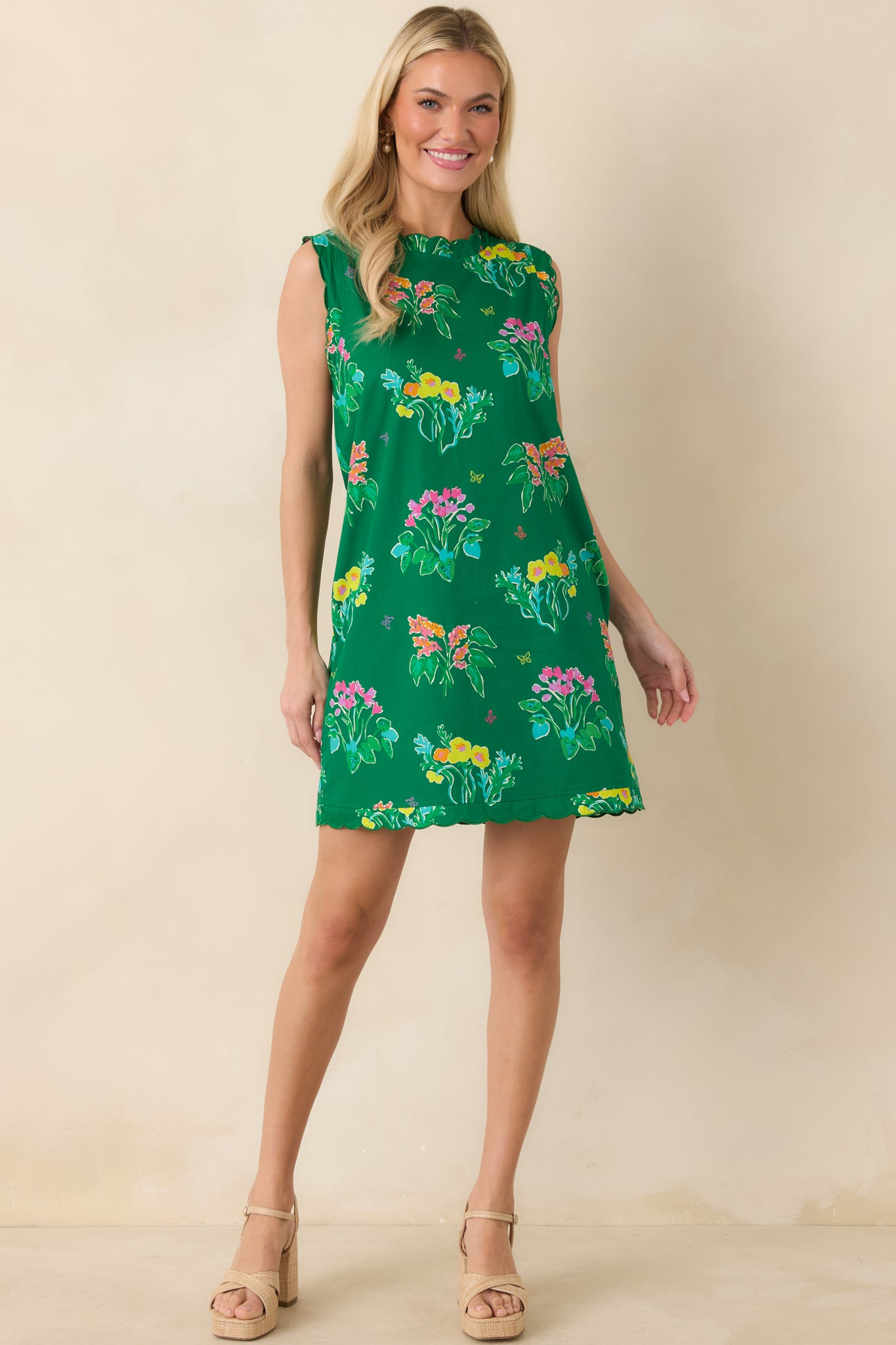 Vibrant green mini dress with playful floral pattern and easy, all-day wear silhouette.