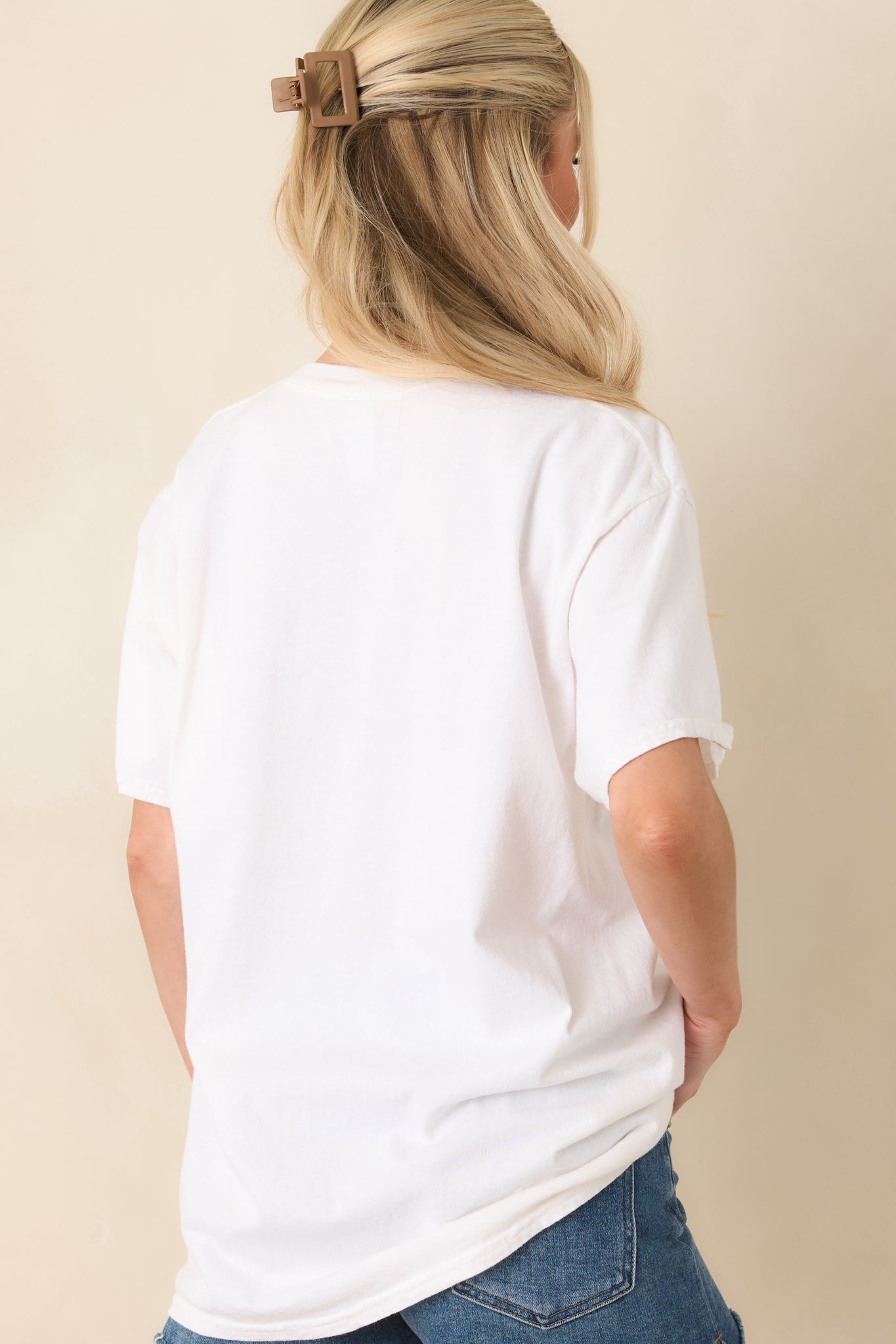 Rear view of the white oversized tee showcasing the smooth, unprinted cotton fabric and relaxed fit.