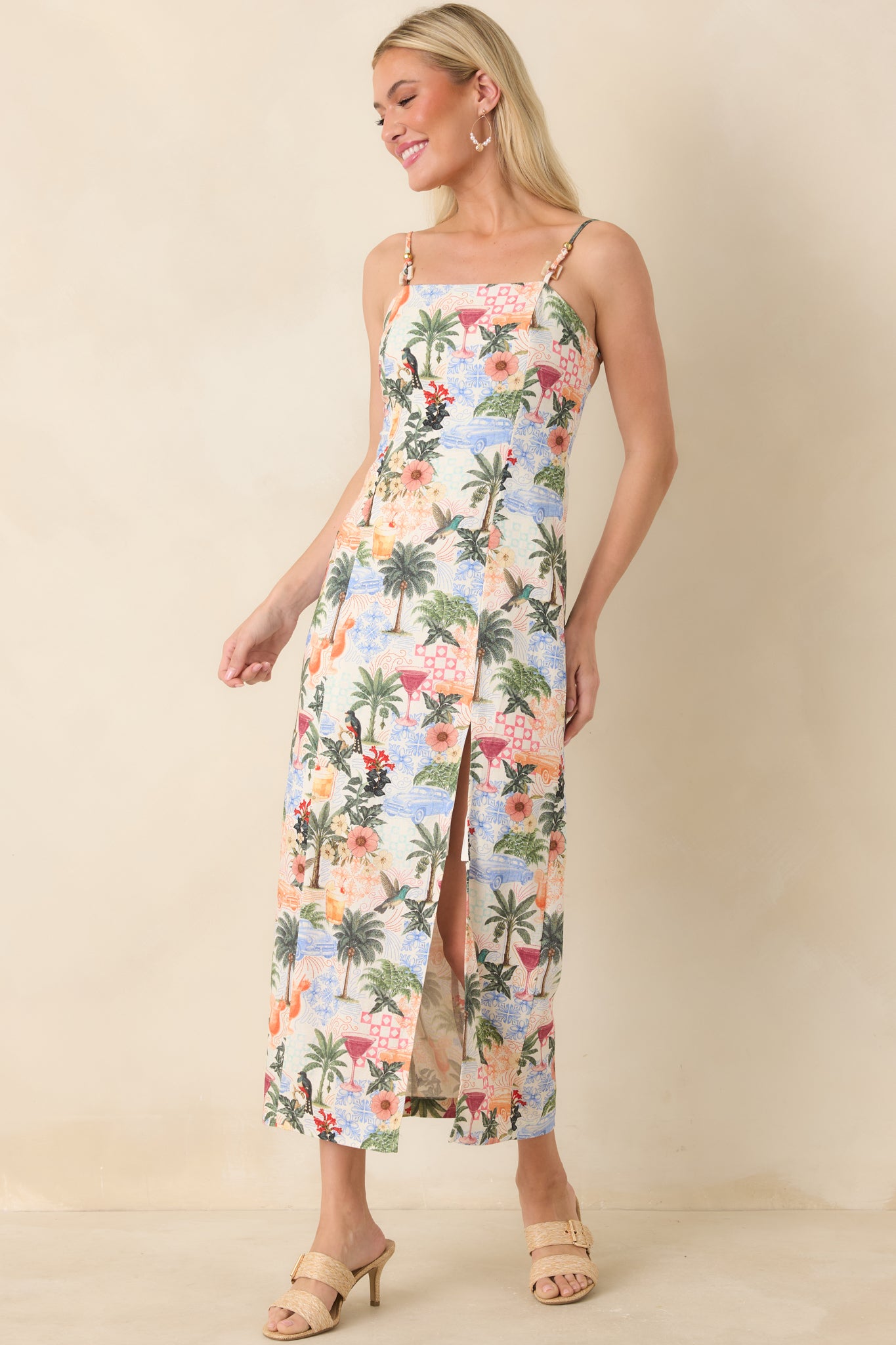 Tropical print midi dress with fitted bodice, airy skirt, and subtle side slit.