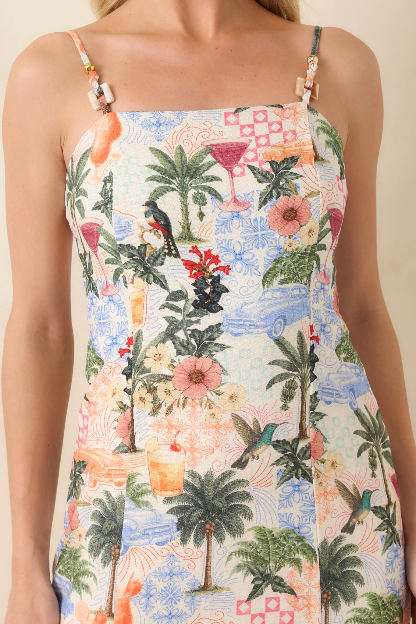 Close-up of beaded strap detail with colorful tropical print fabric.