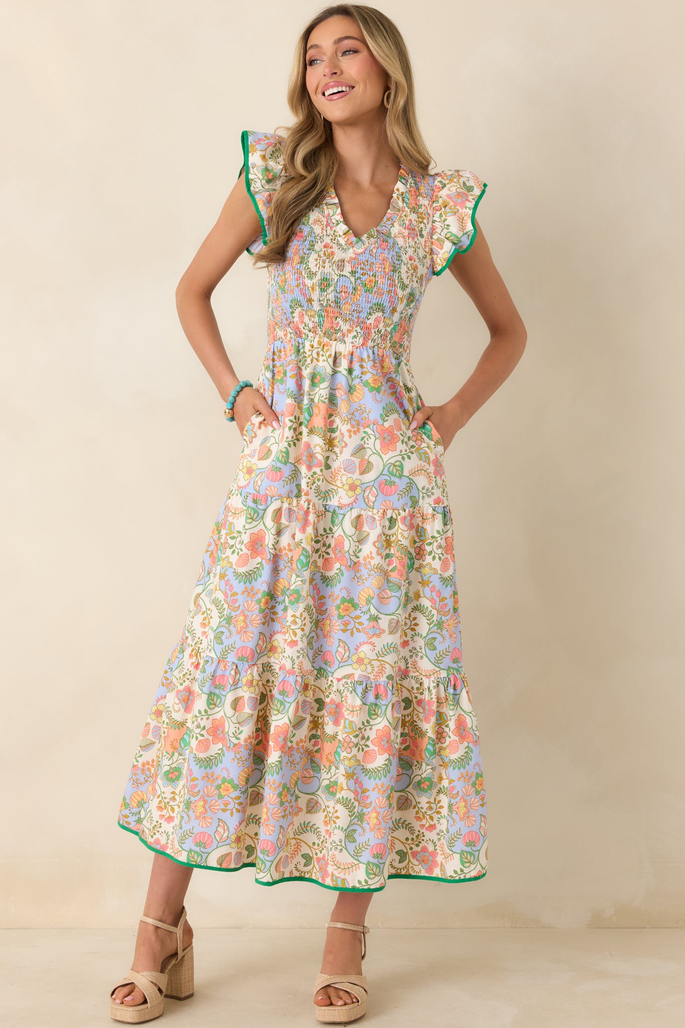 Floral paisley cotton maxi featuring detailed smocking at the bodice and airy tiered layers that give the skirt soft volume and fluid shape.
