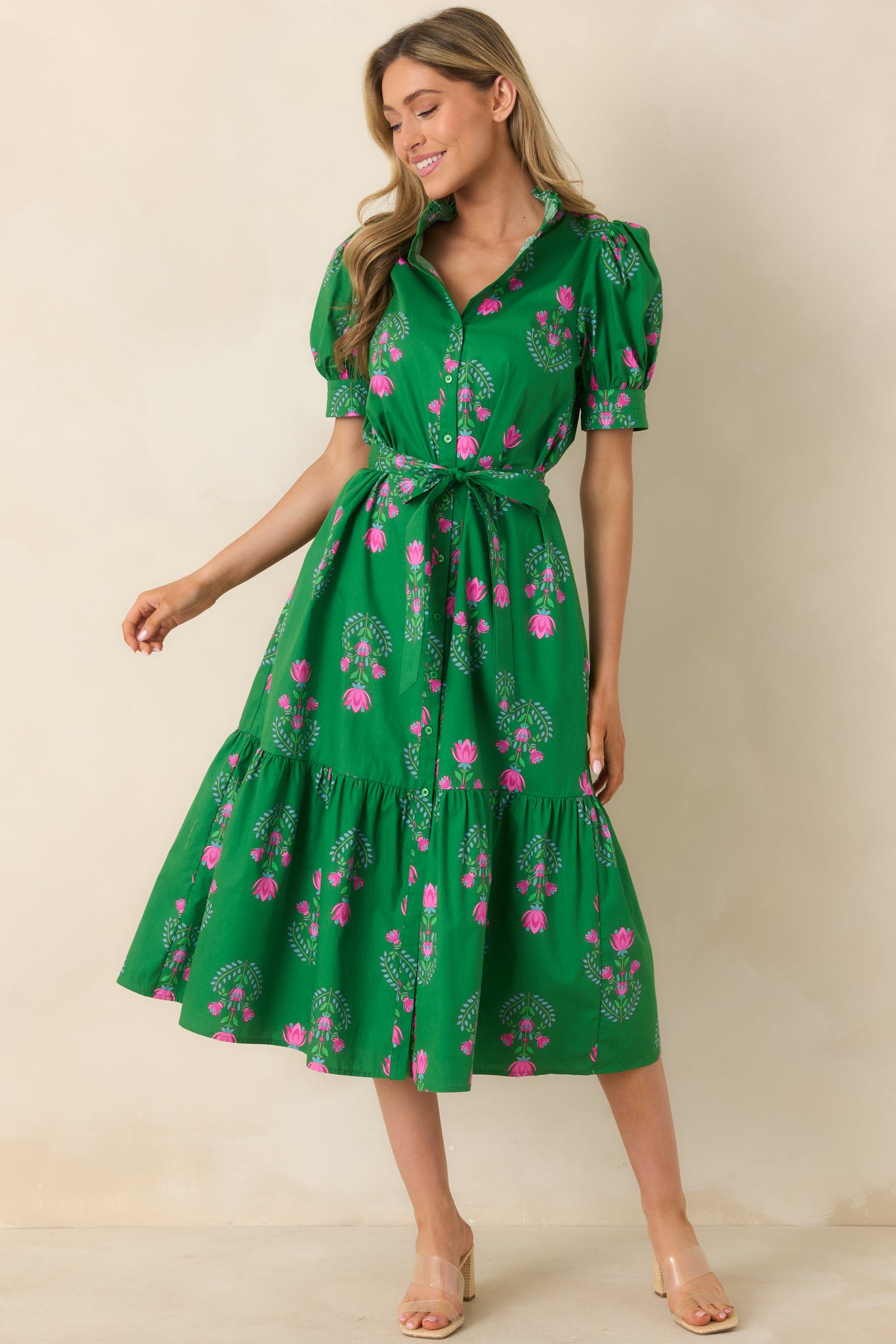 Green midi dress with a high ruffle collar, puff sleeves with stitch detailing, and a tiered skirt.