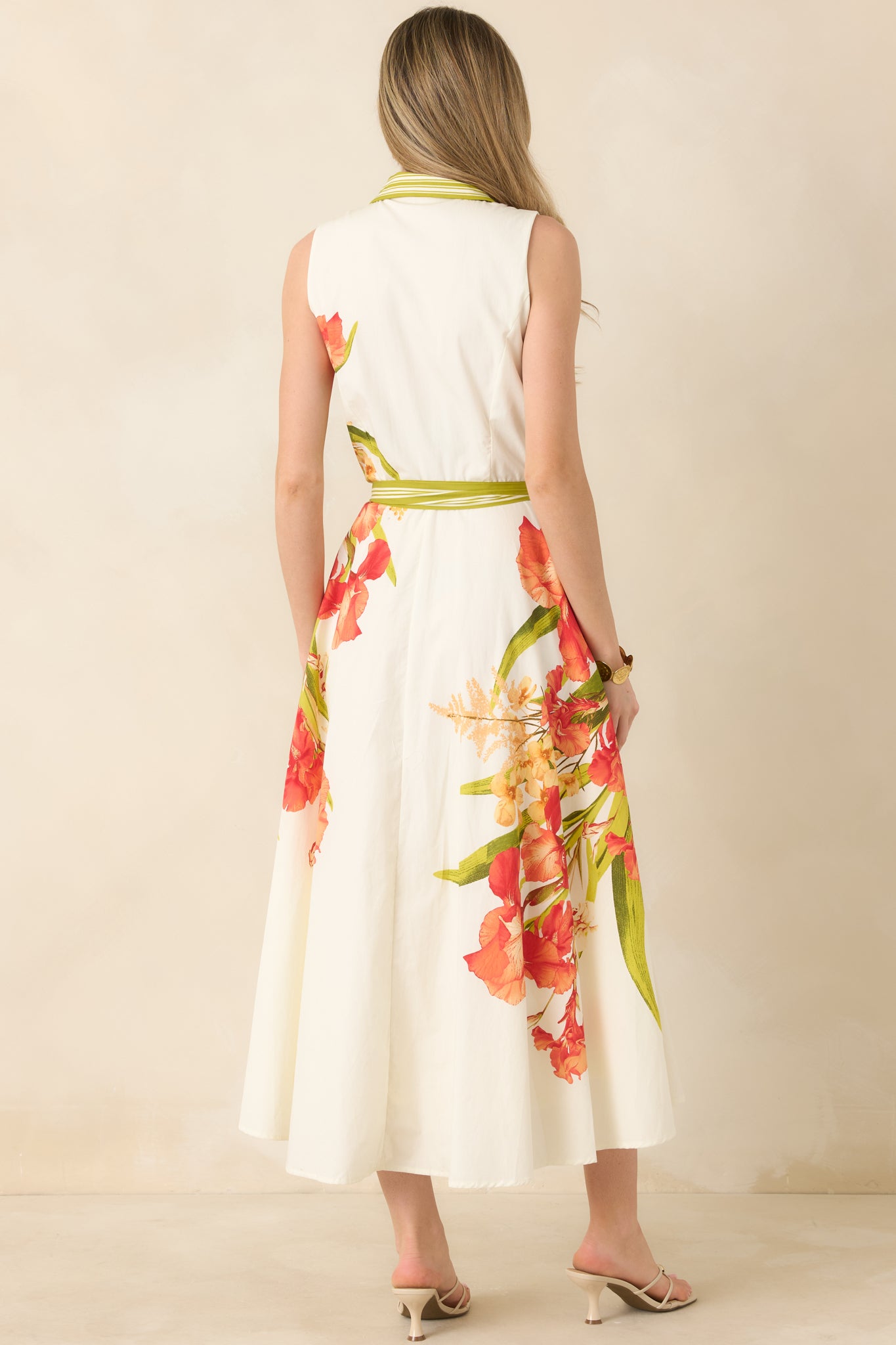 Maxi dress with flowing skirt and adjustable tie belt from rear.