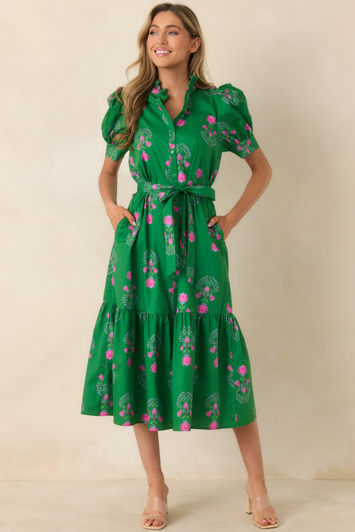 Front view of green midi dress with tiered skirt, functional pockets, and delicate stitch detailing on the sleeves.