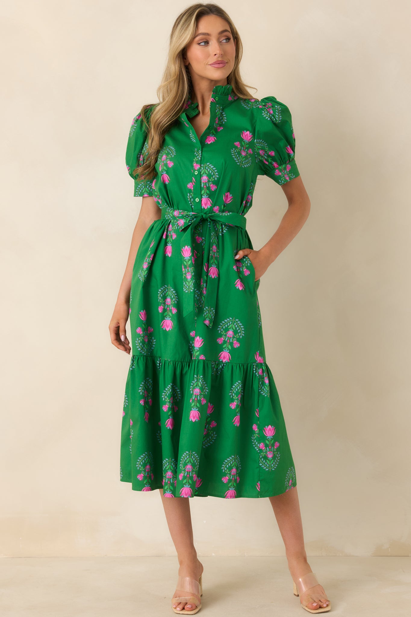 Midi dress with ruffle collar, fitted waist with tie belt, and flowing tiered skirt in floral print.