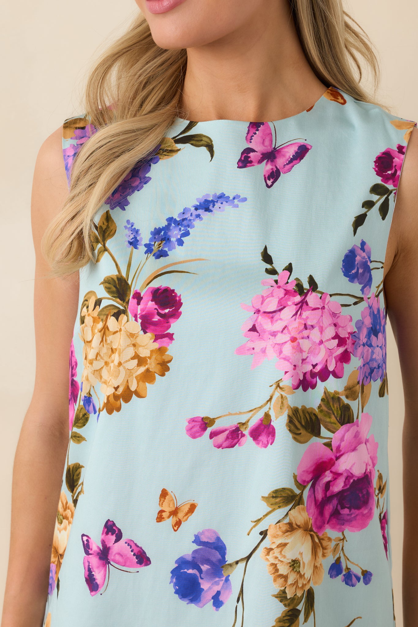 Close-up of the mini dress showing the fabric texture and keyhole button closure detail at the back.