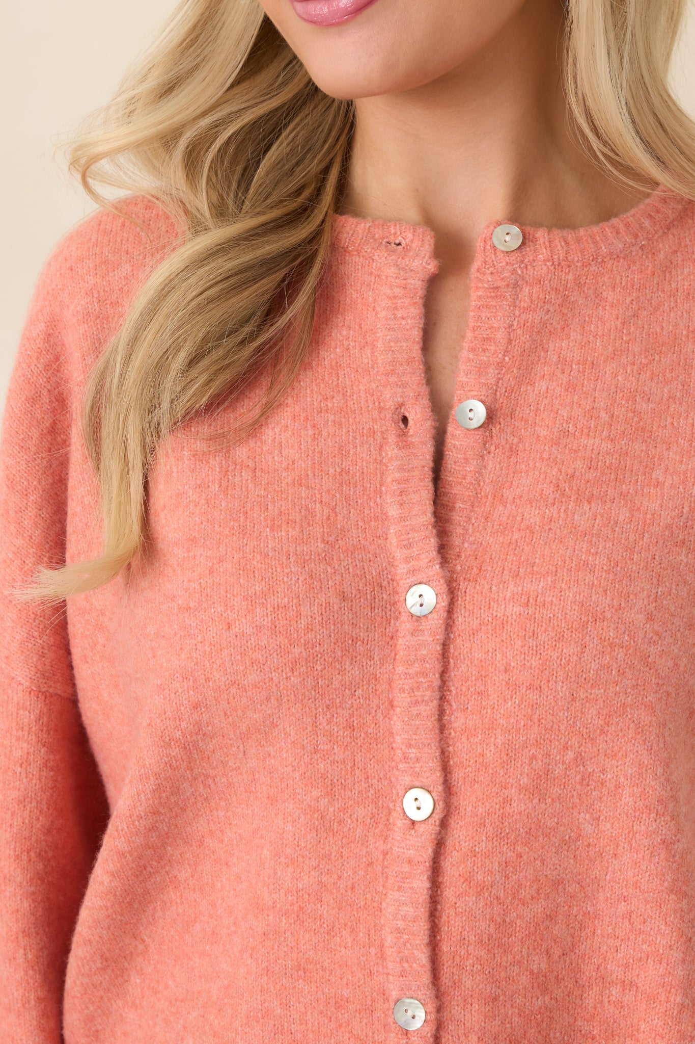Close-up of the soft knit fabric and ribbed trim along the neckline, cuffs, and hem for a polished, classic look.