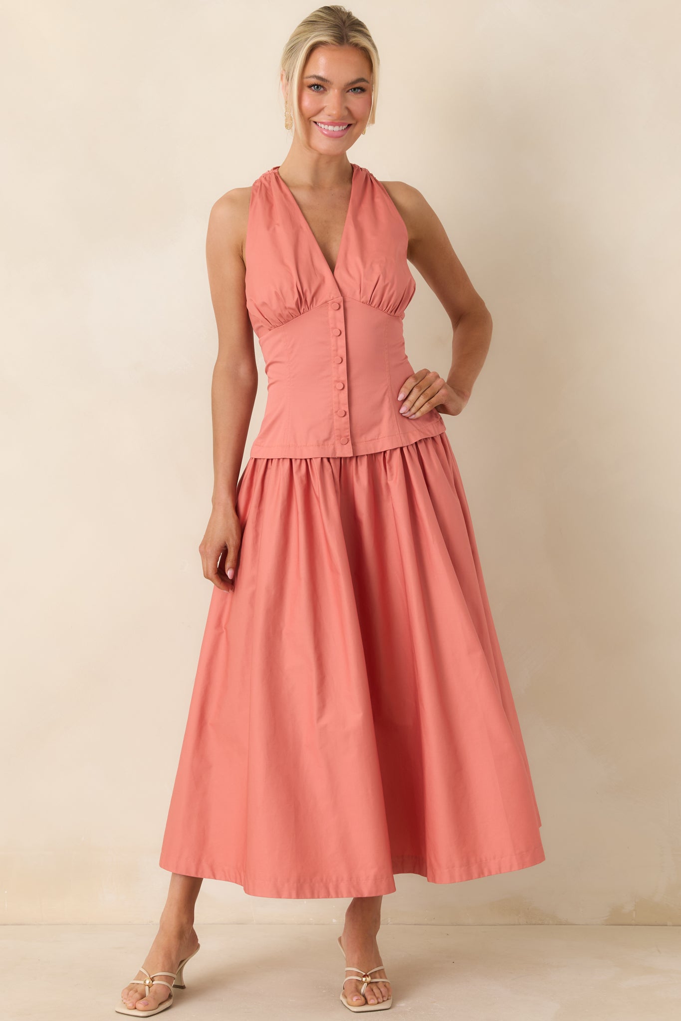 Tailored midi dress with button front detail and flowing skirt.