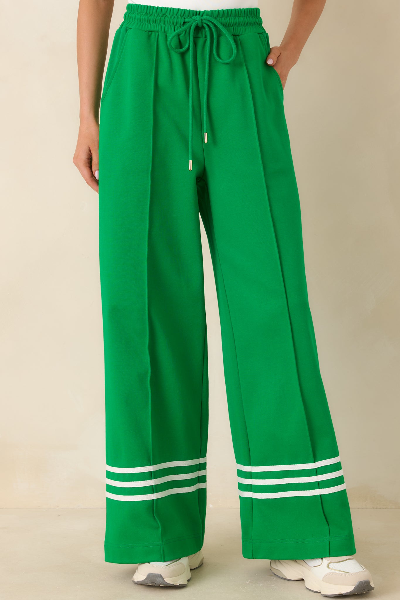 Soft cotton fabric with side pockets and tailored stitching, emphasizing the modern stripe accent at the hem.