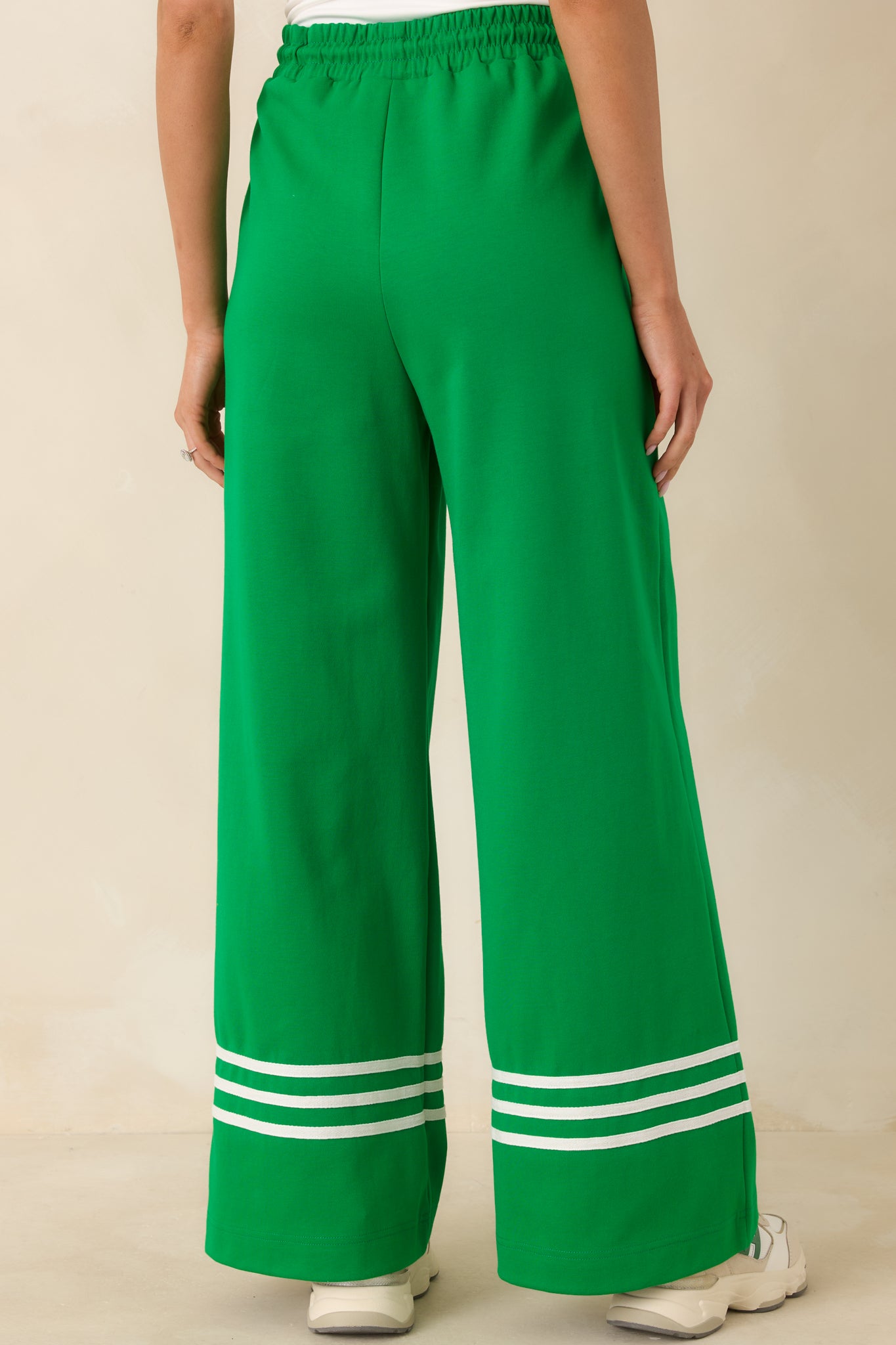 Rear view of the pants highlighting the relaxed wide-leg fit, elastic waistband, and subtle back silhouette of the cotton blend fabric.