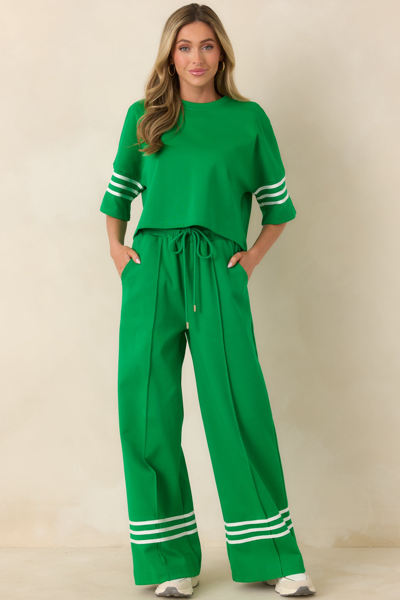 Relaxed-fit short sleeve top in a cotton blend, featuring a straight silhouette and contrast stripes along the sleeves for subtle detail.