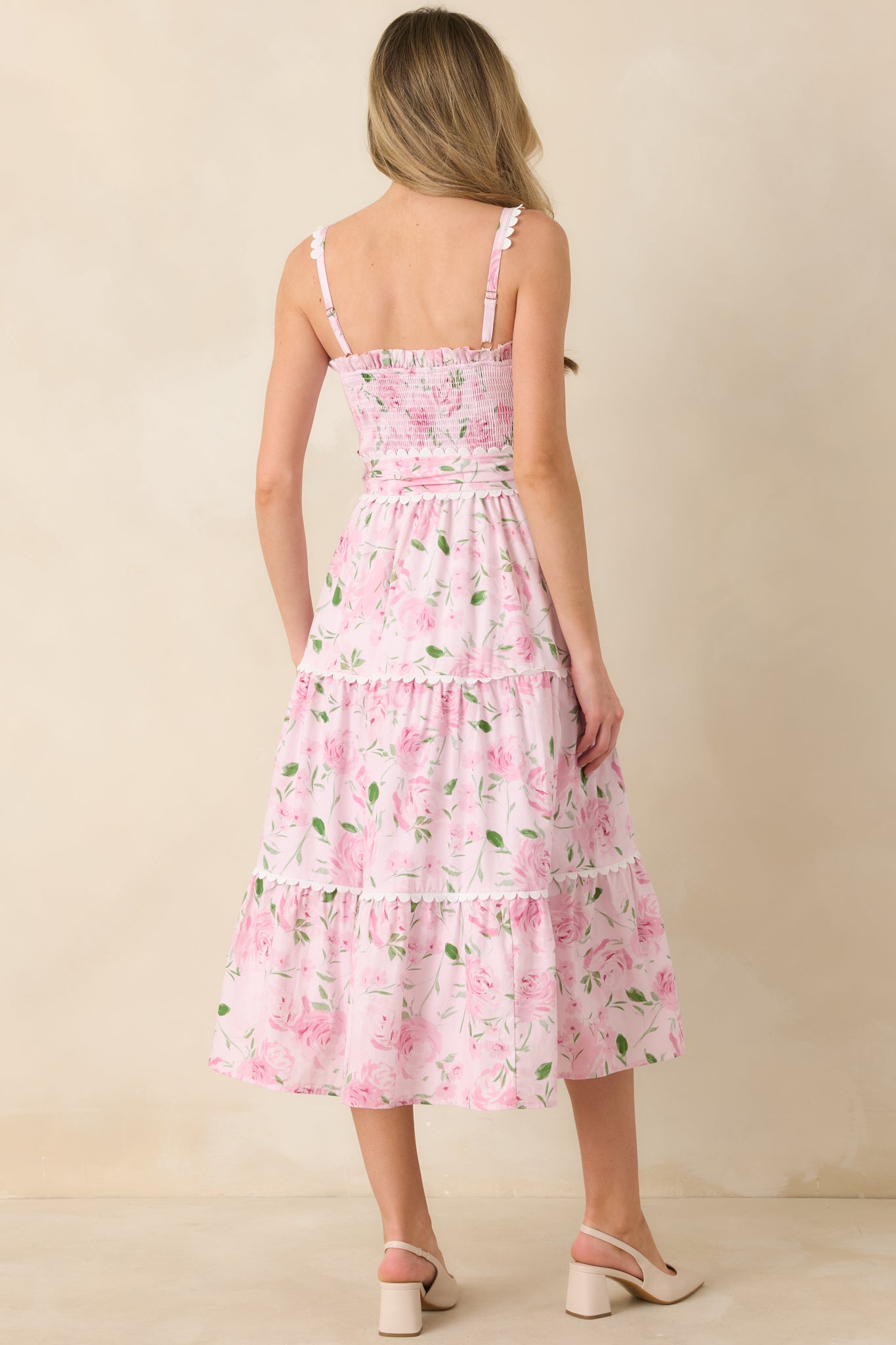 Back view of the pink maxi dress showcasing the square neckline, adjustable straps, and tiered skirt flow.