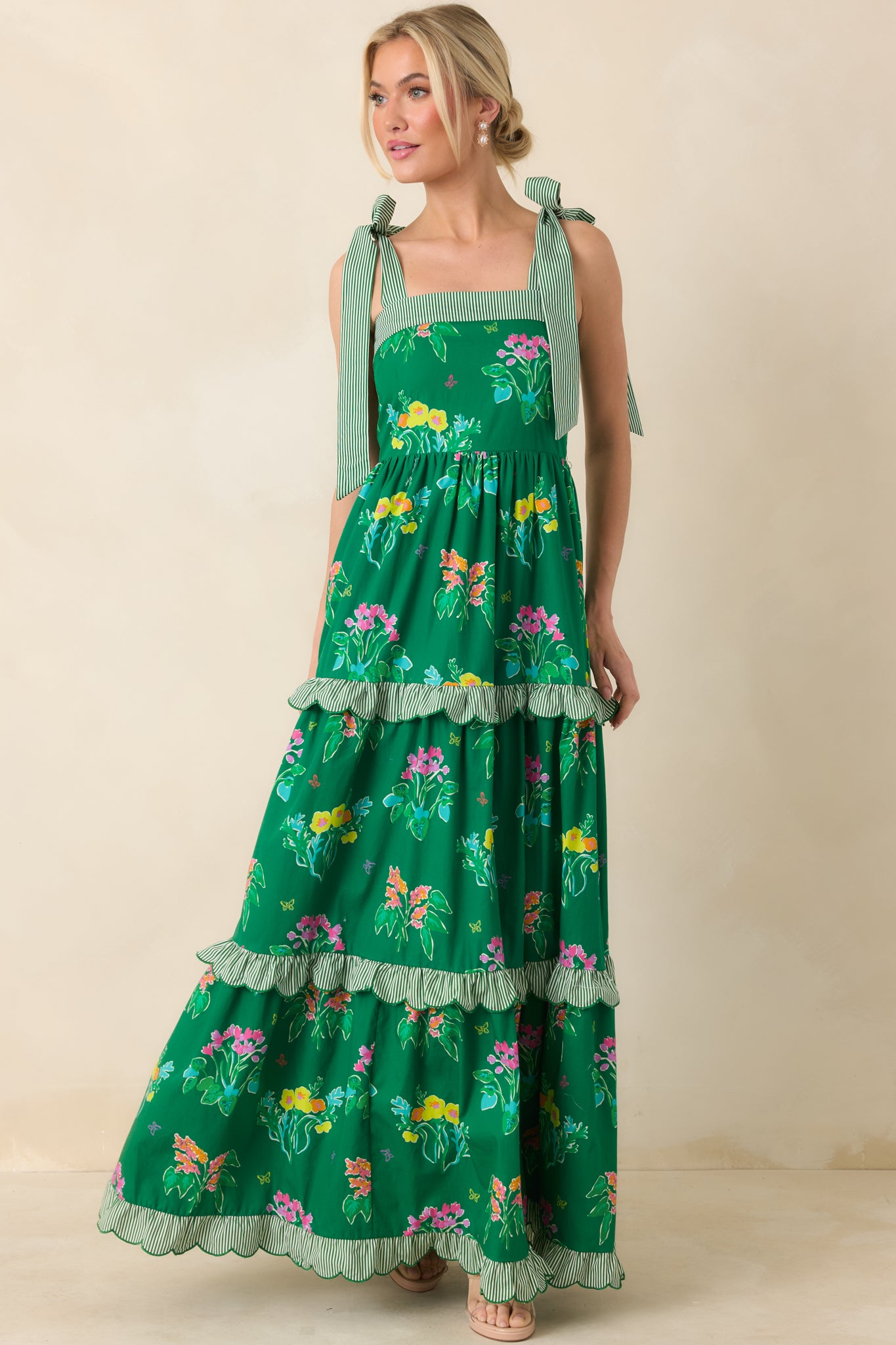 Vibrant maxi featuring square neckline, delicate striped tie straps, and scalloped tiered trim.