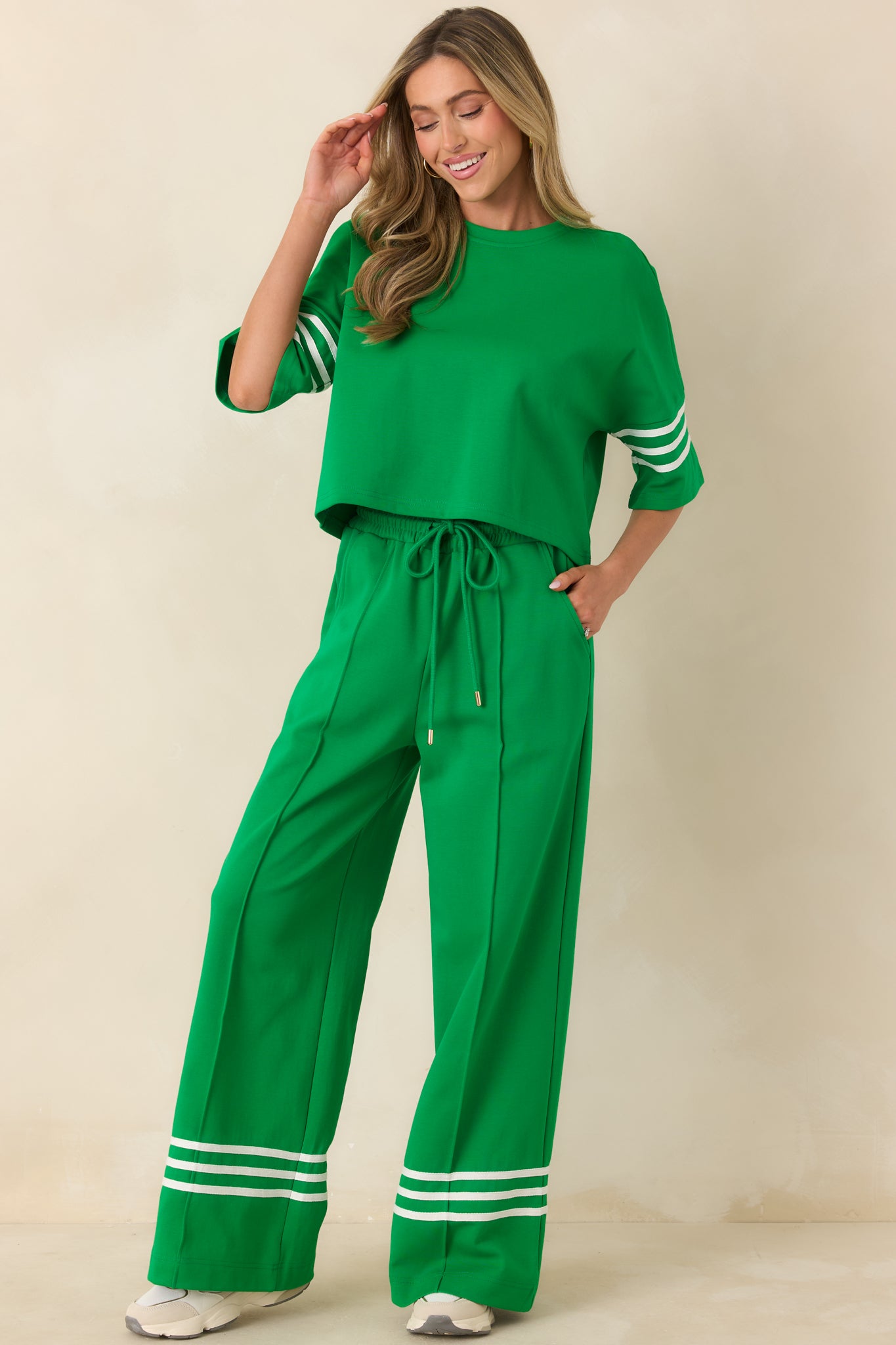 Soft cotton blend top with a classic crew neckline, relaxed short sleeves, and subtle contrast stripe accents for a sporty touch.