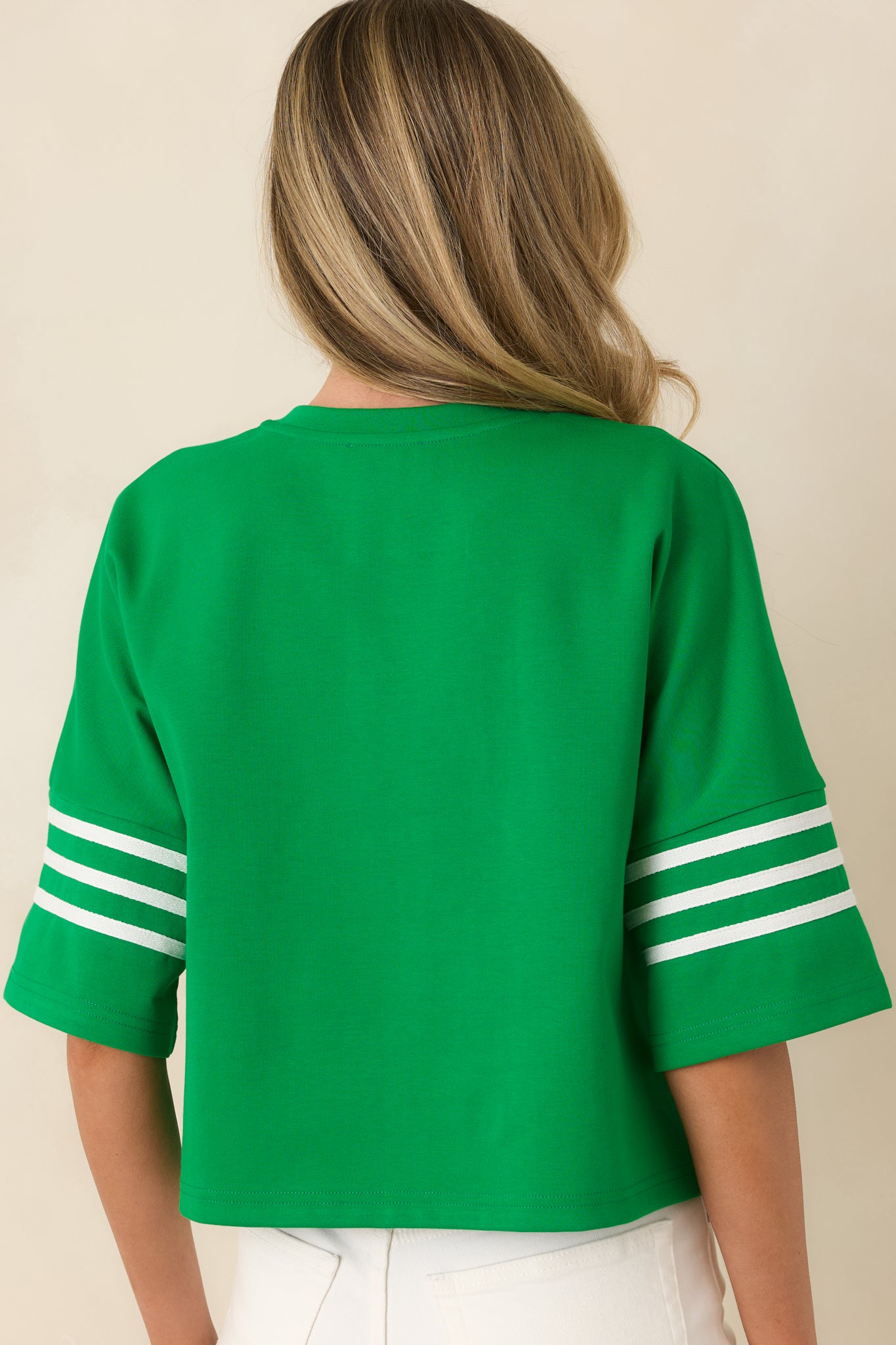 Rear view of the cotton blend top showcasing the relaxed boxy silhouette, short sleeves, and subtle contrast stripe detailing.