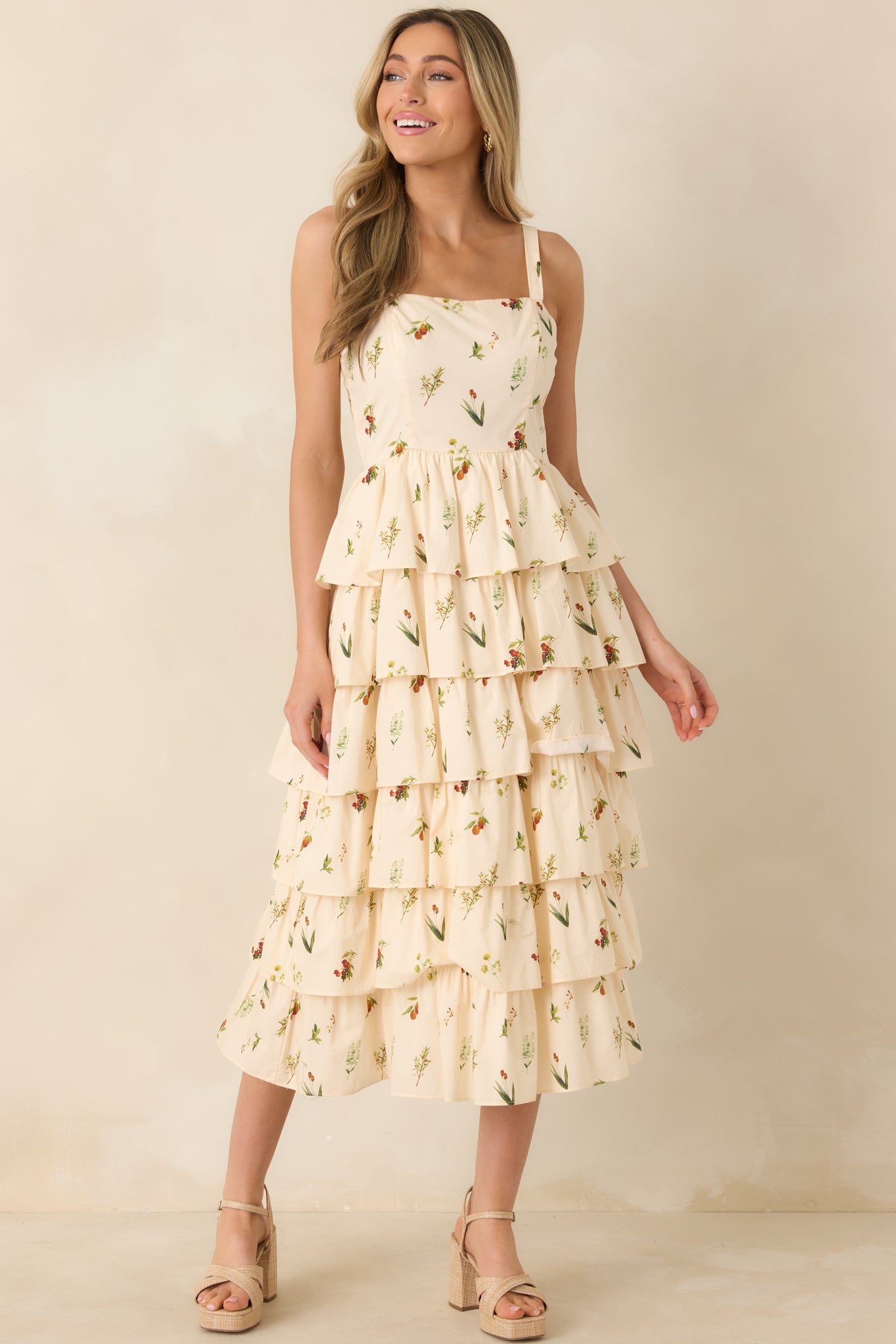 Full body angled shot of the ivory midi dress highlighting its multicolor floral print, square neckline, and structured paneling.