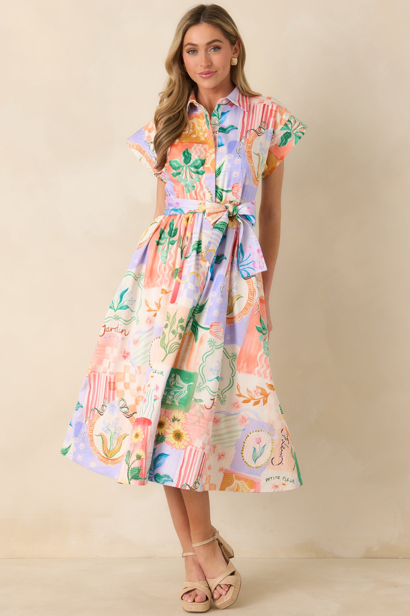 Peach multicolored midi dress with collared neckline, button-front bodice, and self-tie waist belt, finished with a softly flared skirt.