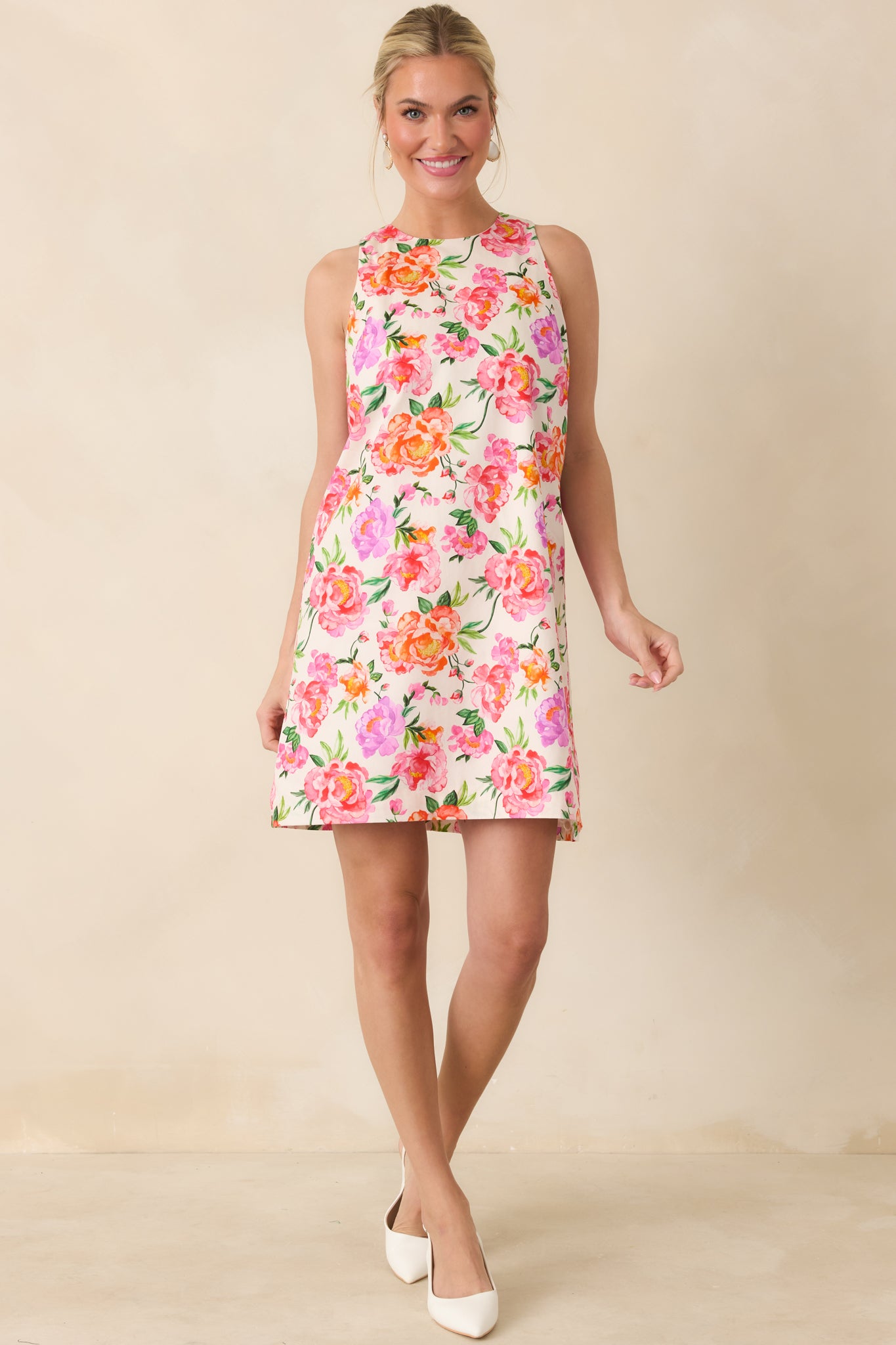 Pink multi floral cotton mini dress with a relaxed shift silhouette and vibrant floral print.